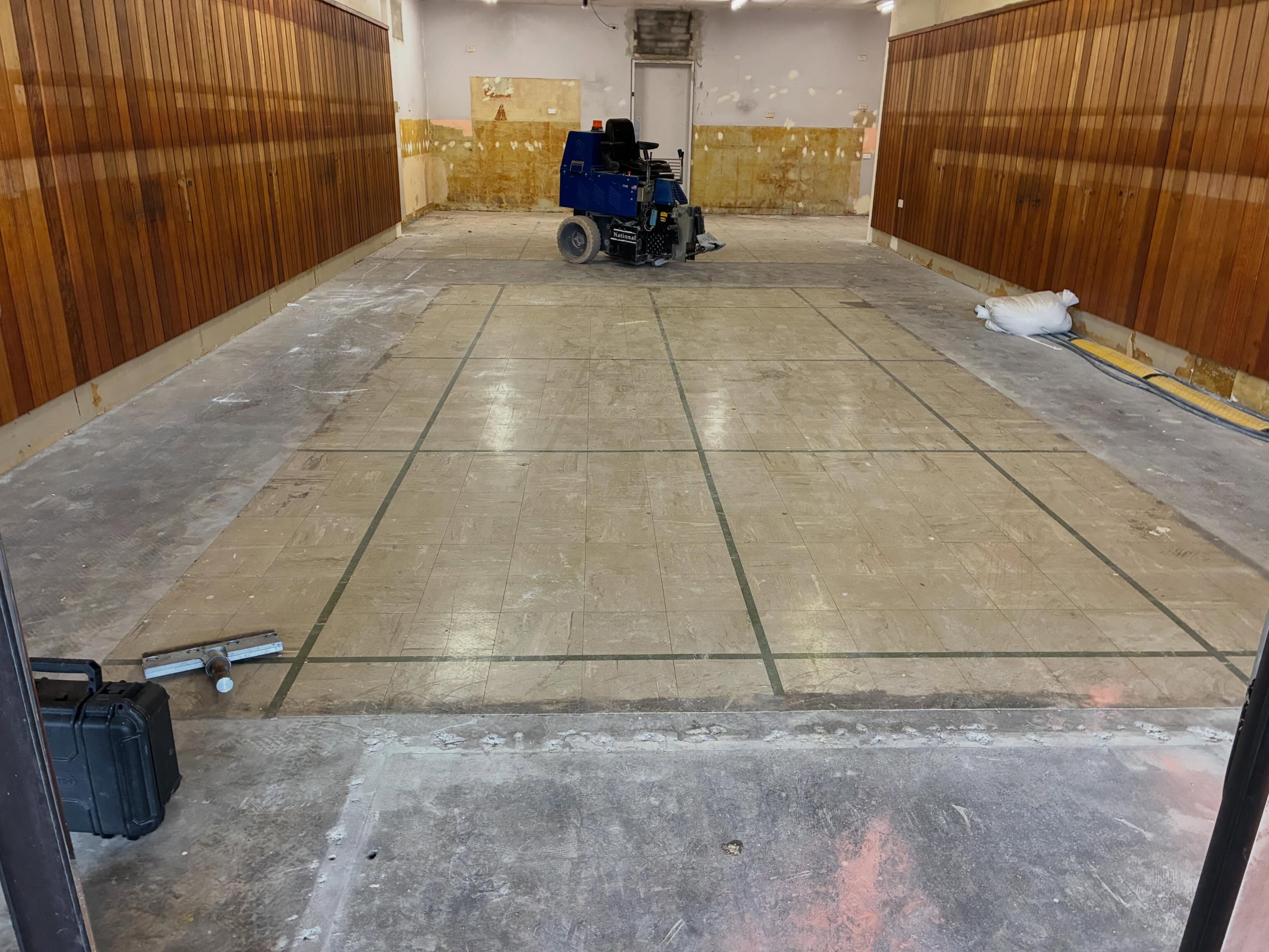 Commercial tile removal in progress on a concrete slab