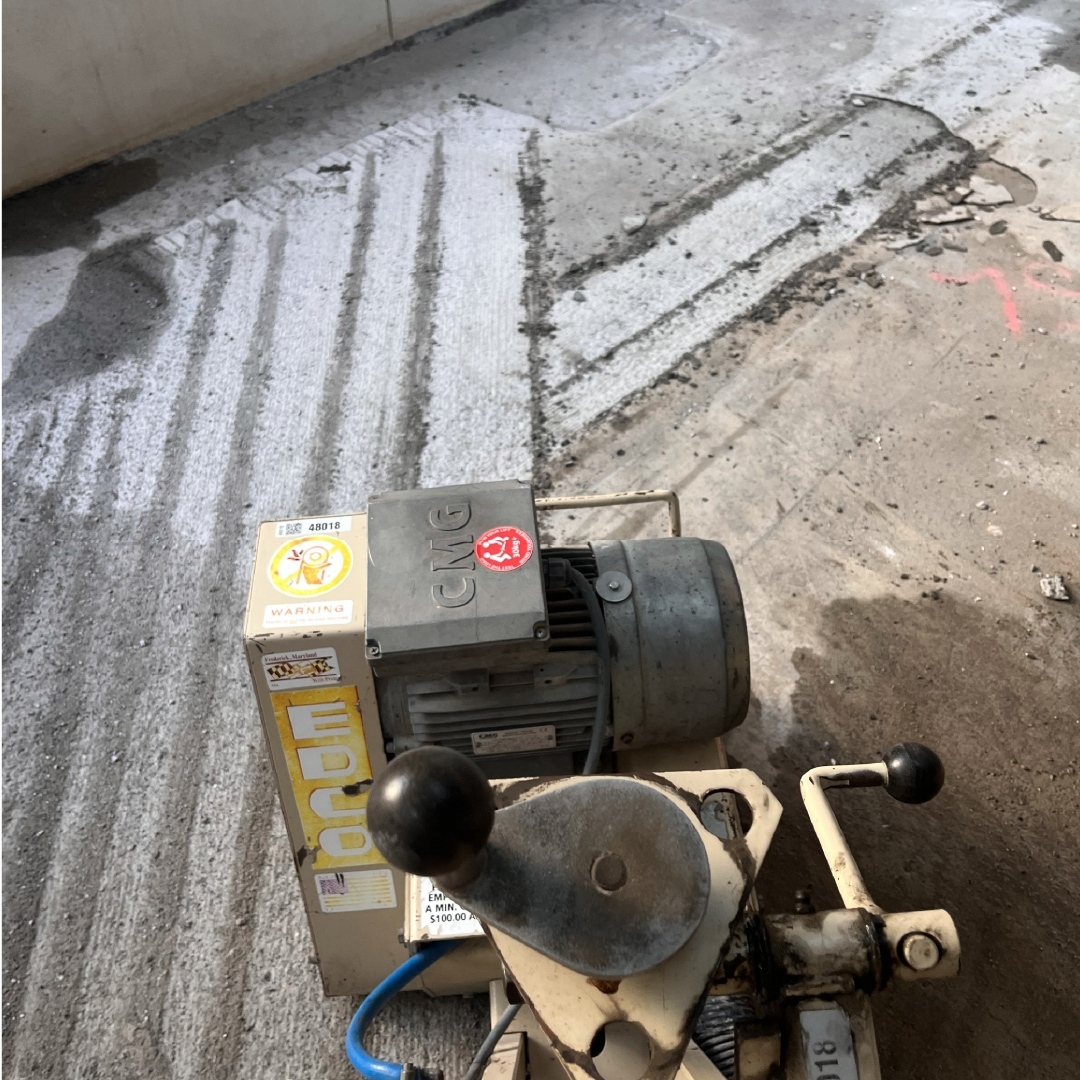 Concrete scarifying to remove a thick coating from a slab