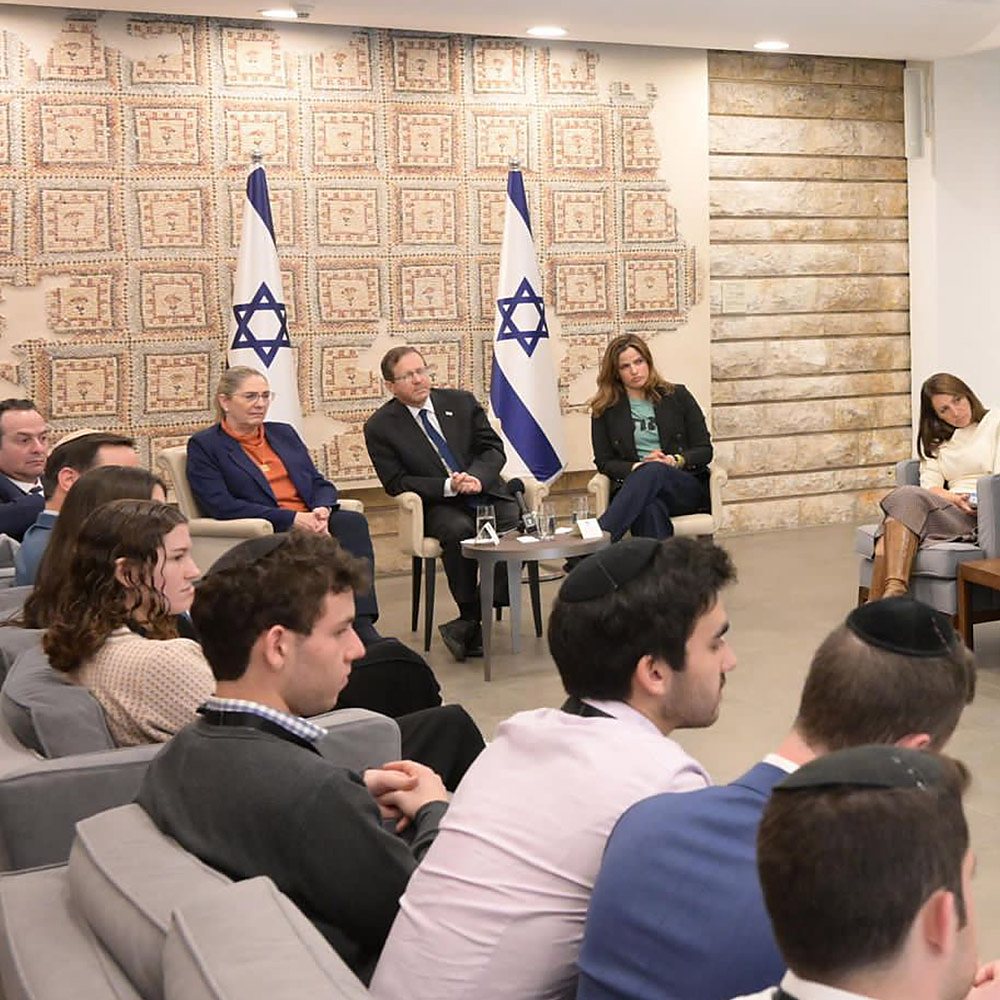 Delegation participants attend a seated briefing at President Herzog’s residence.