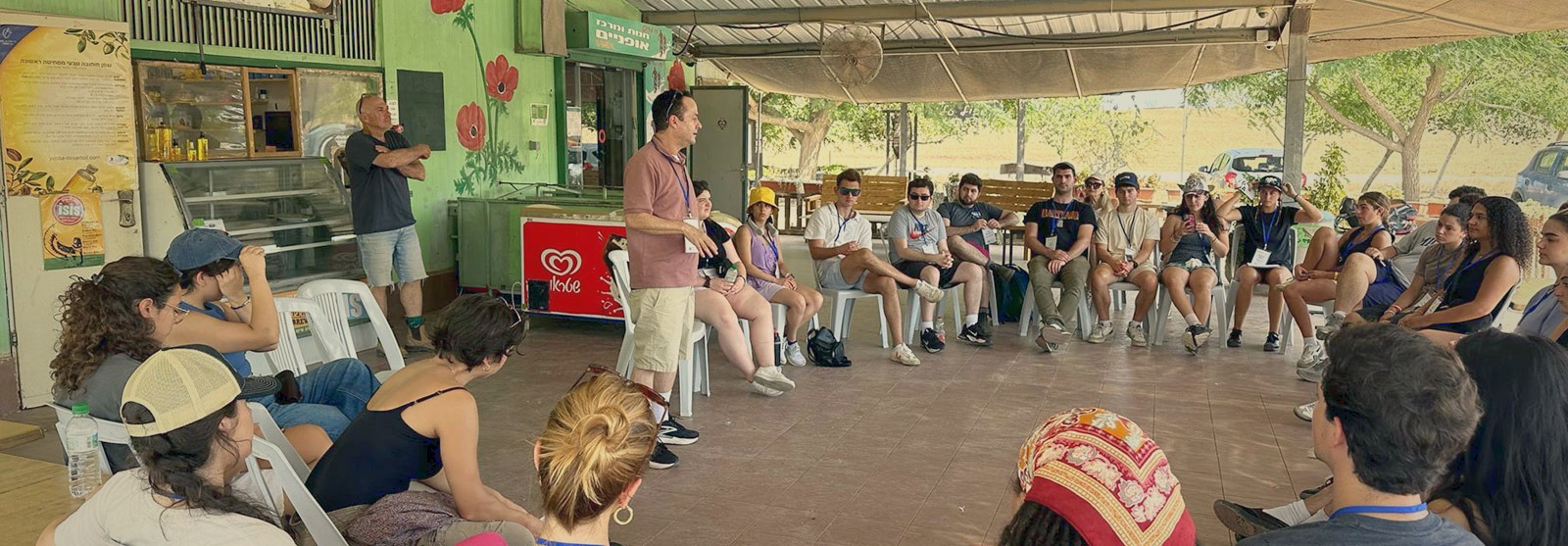 Students gather in a circle for an outdoor discussion.