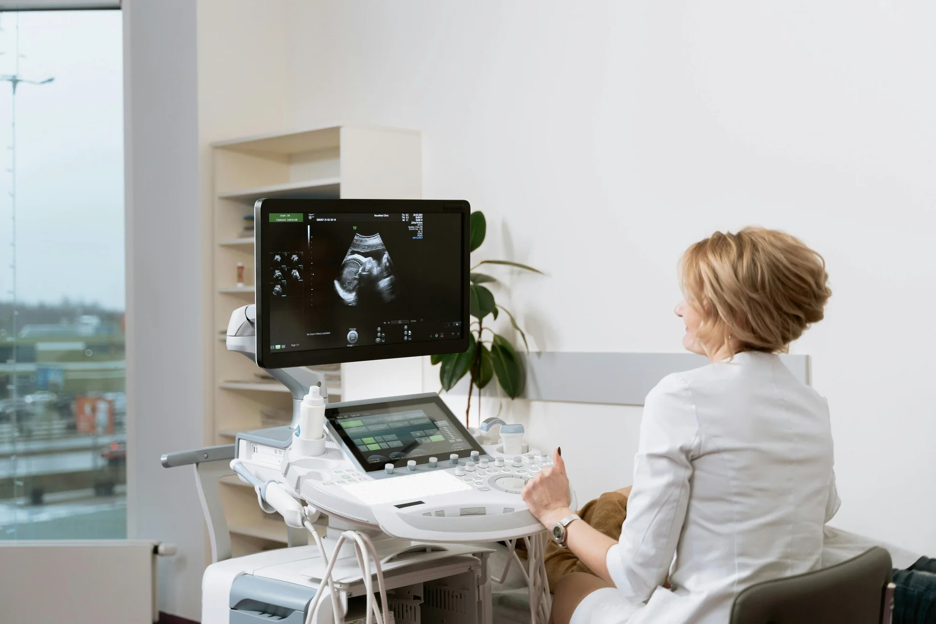 A practitioner performs an ultrasound, the image shown on the monitor