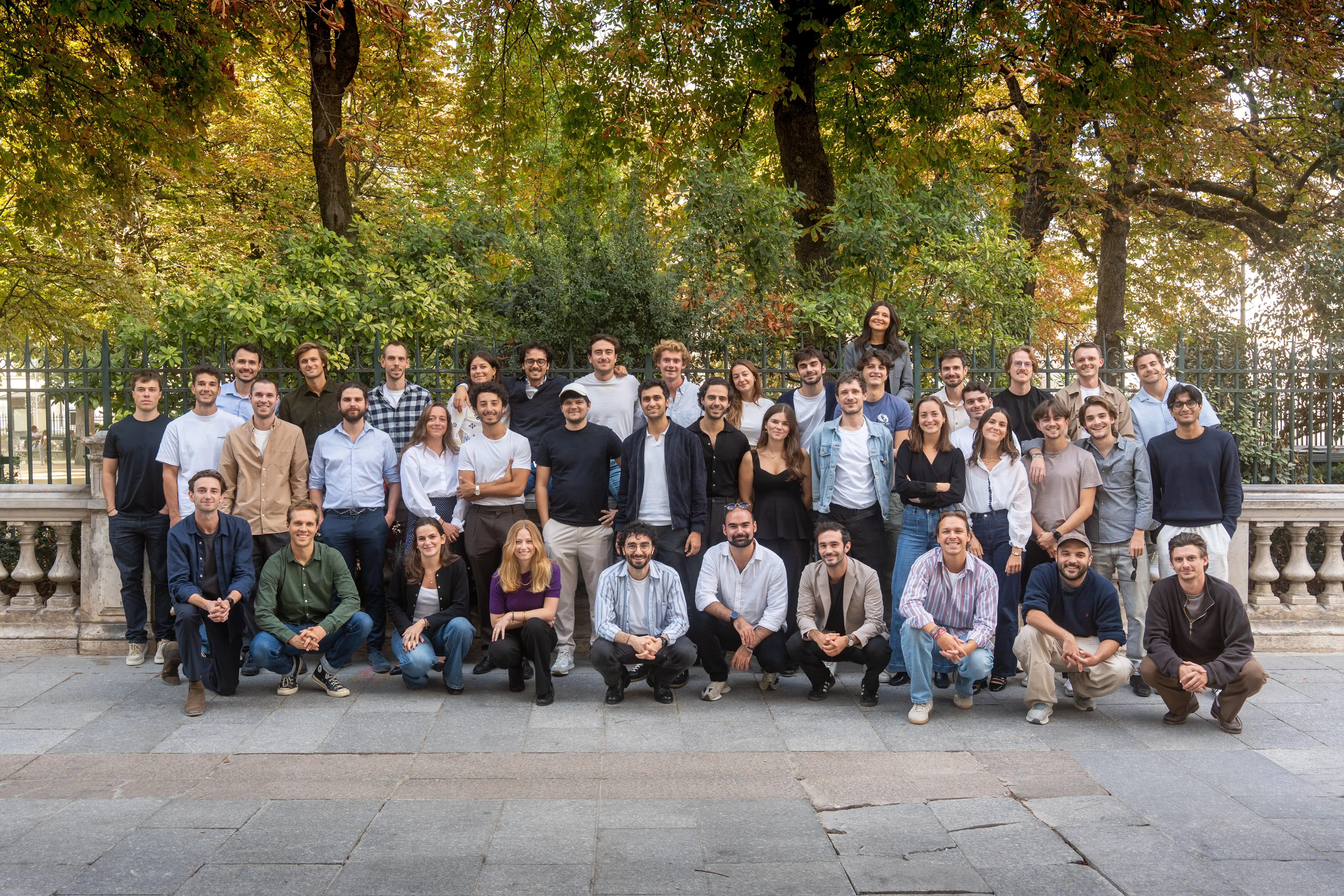 Group photo of the Vocca team outdoors in front of a stone balustrade
