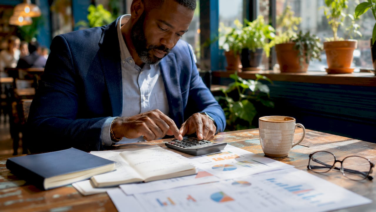 Hands calculating startup cash runway metrics