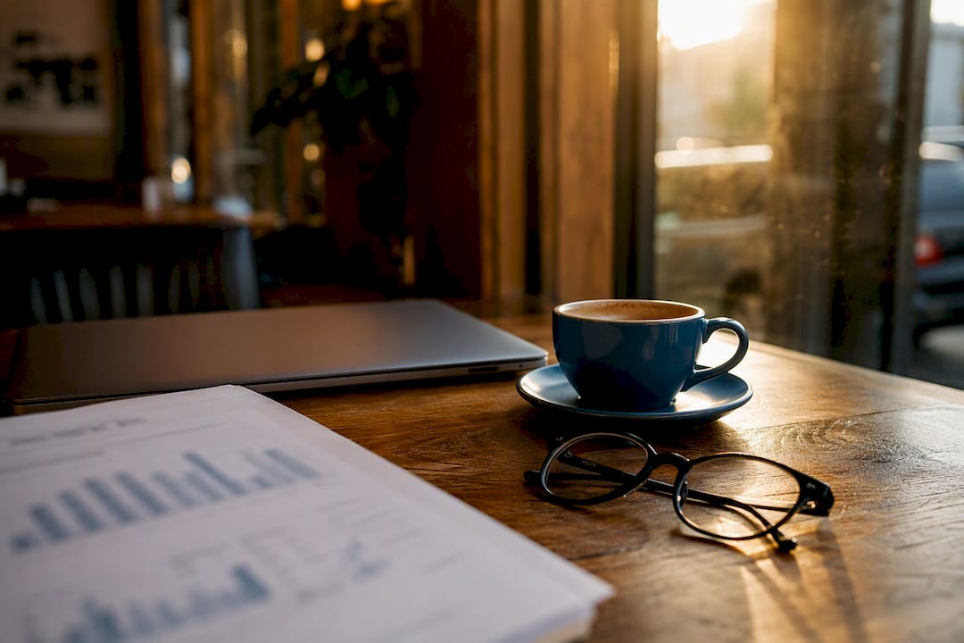 Desk with financial report and coffee cup