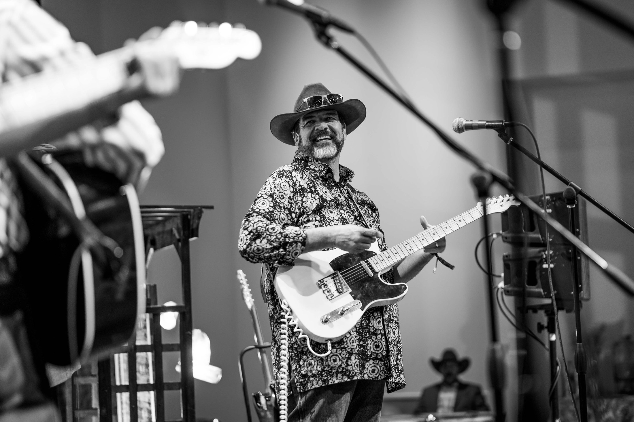 A smiling guitarist at an event
