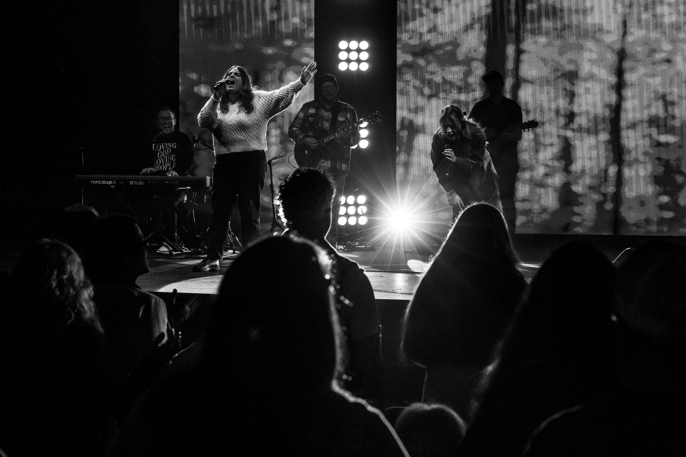 Worship band on stage with the congregation in the foreground