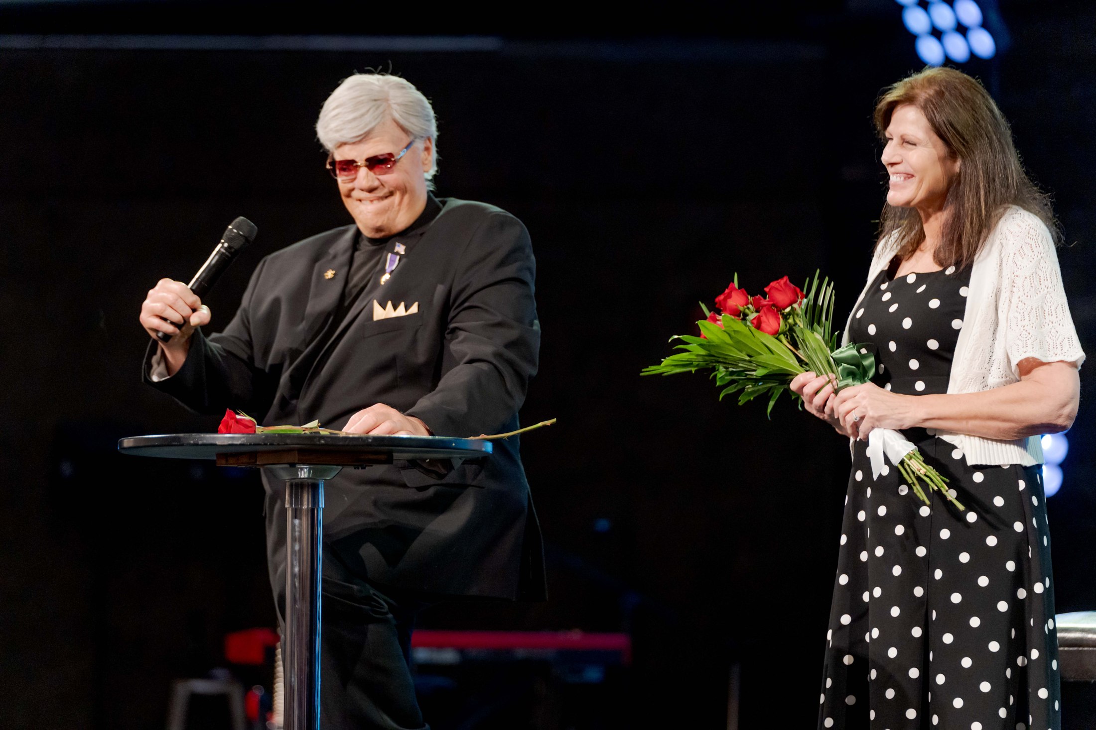 A guest speaker and a church leader on stage