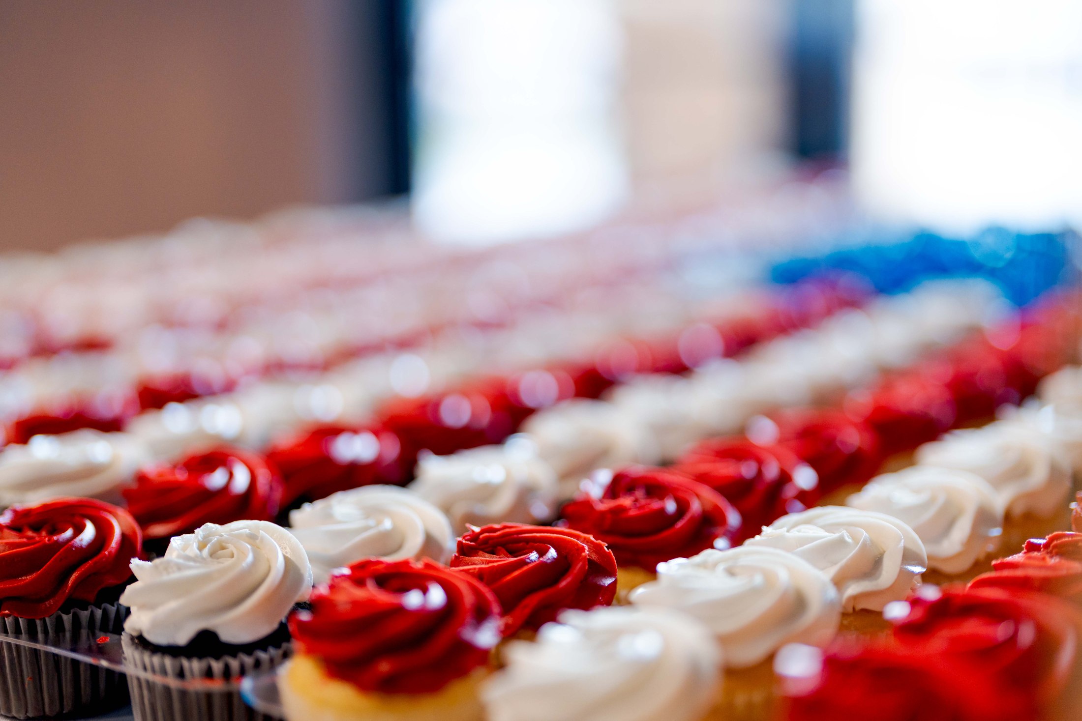Rows of red and white cupcakes prepared for a church event