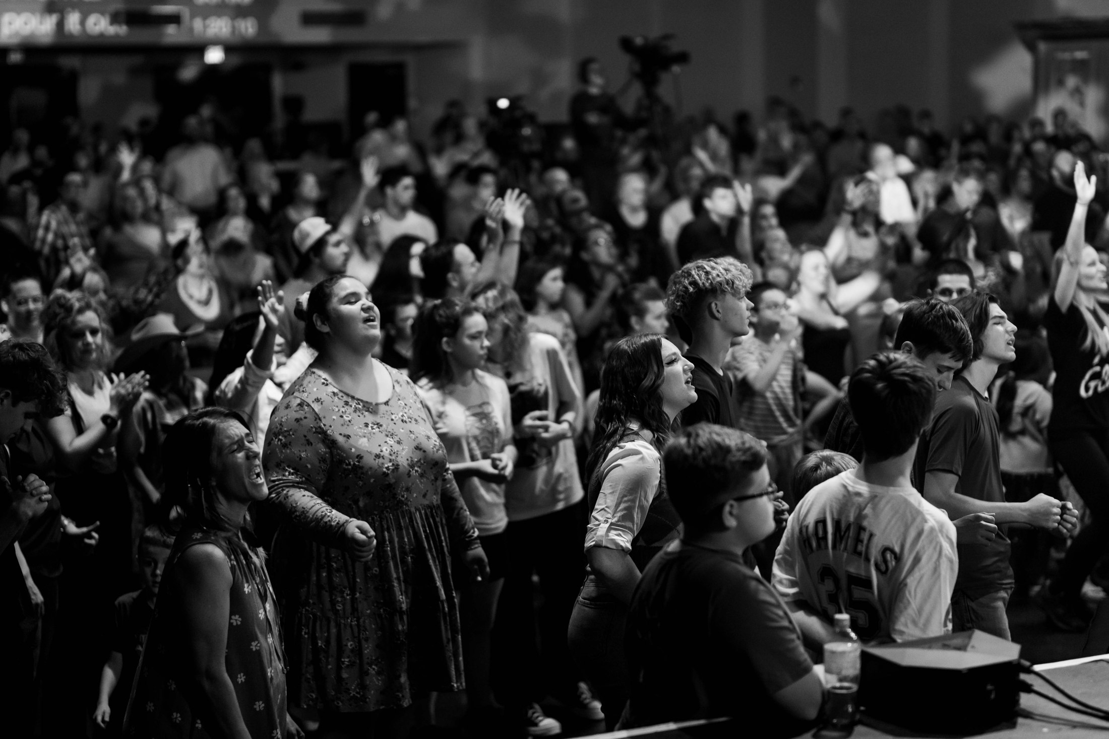 Members of the congregation worshipping, photographed in black and white