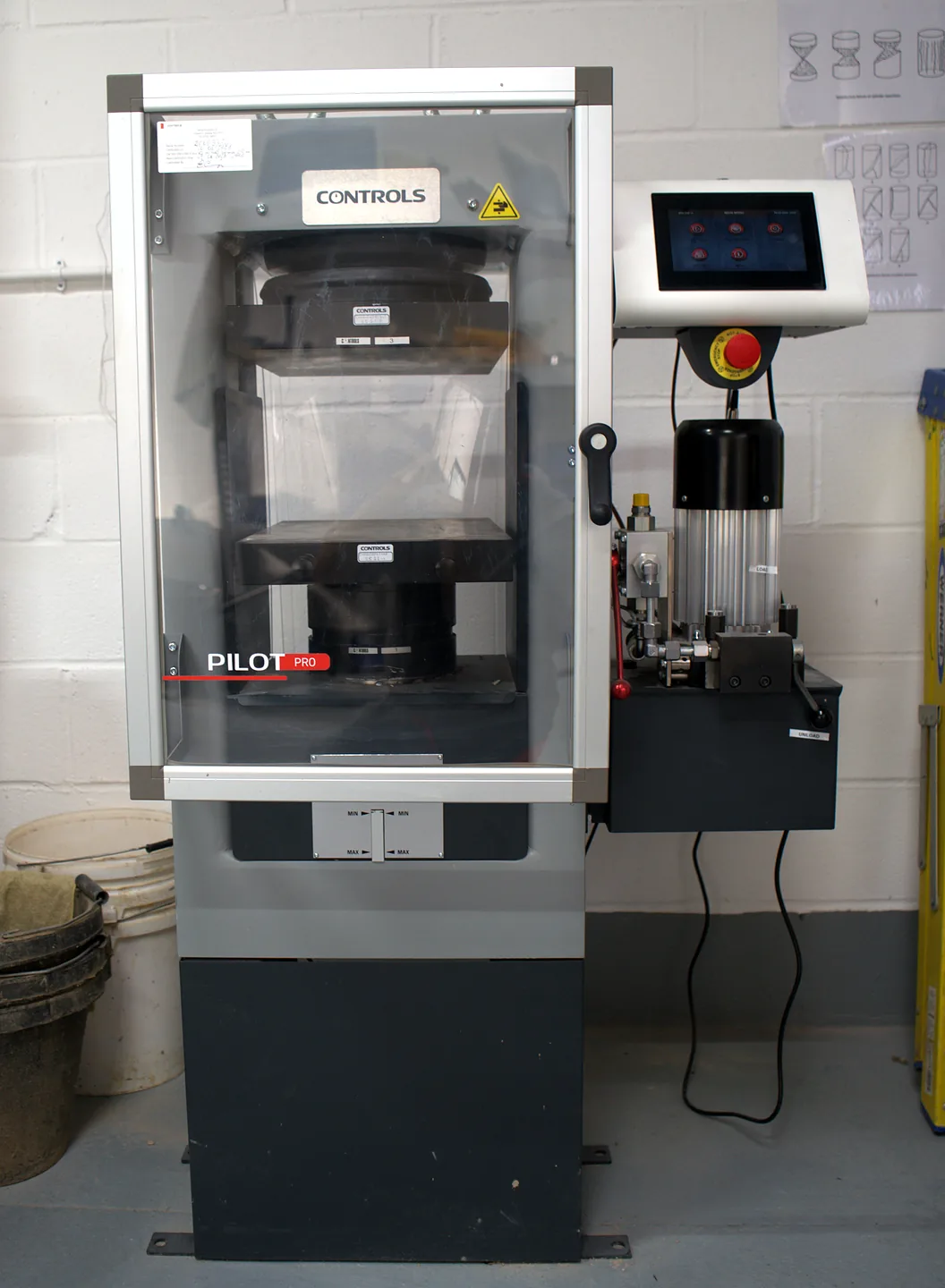 Compression testing machine with touchscreen control panel in the Hixtra laboratory
