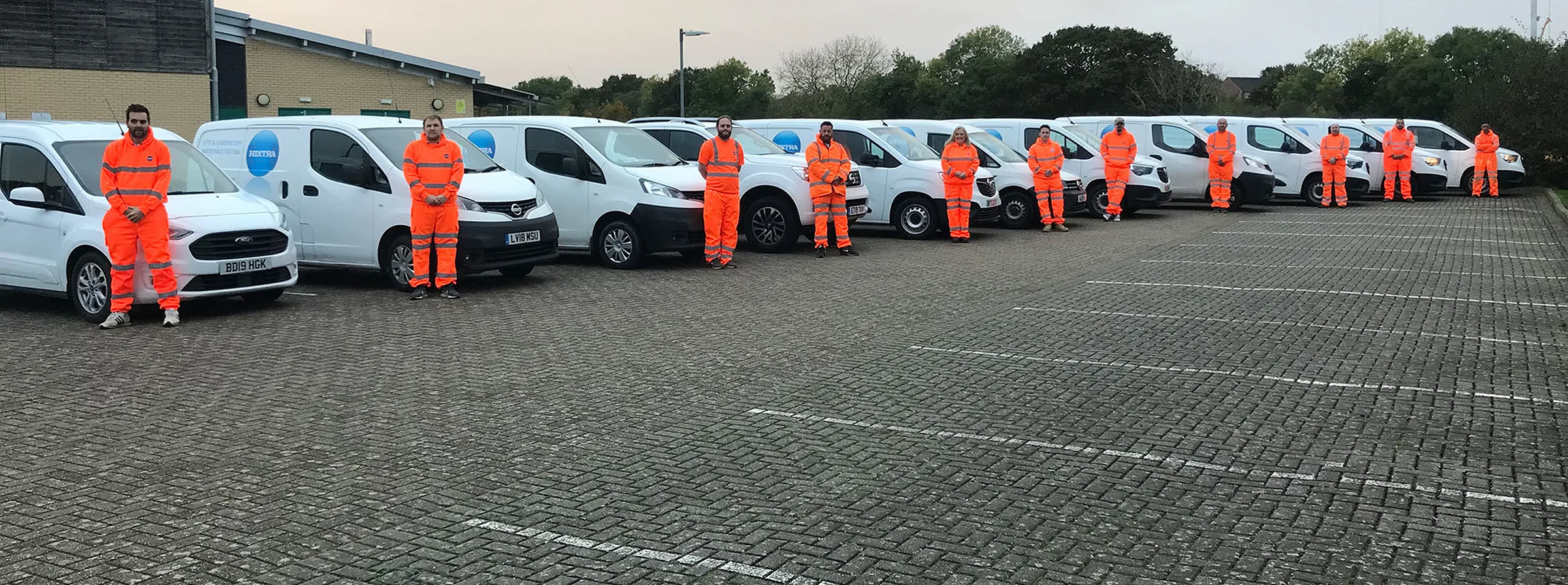 Hixtra vans and staff lined up outside
