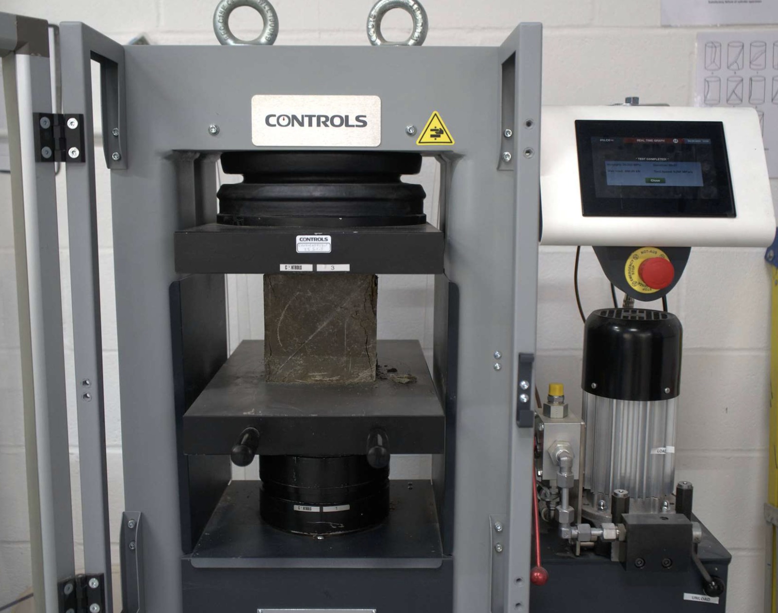 Concrete cube in a compression testing machine