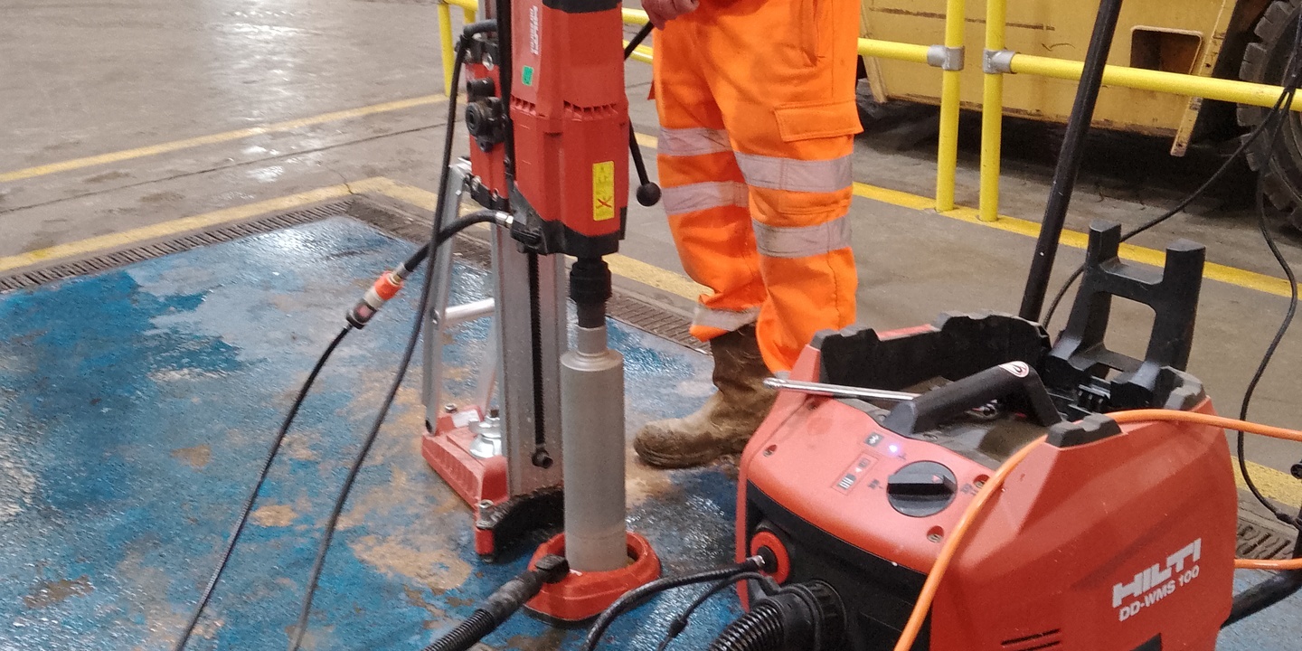 Concrete core being extracted to investigate the subbase beneath a warehouse floor
