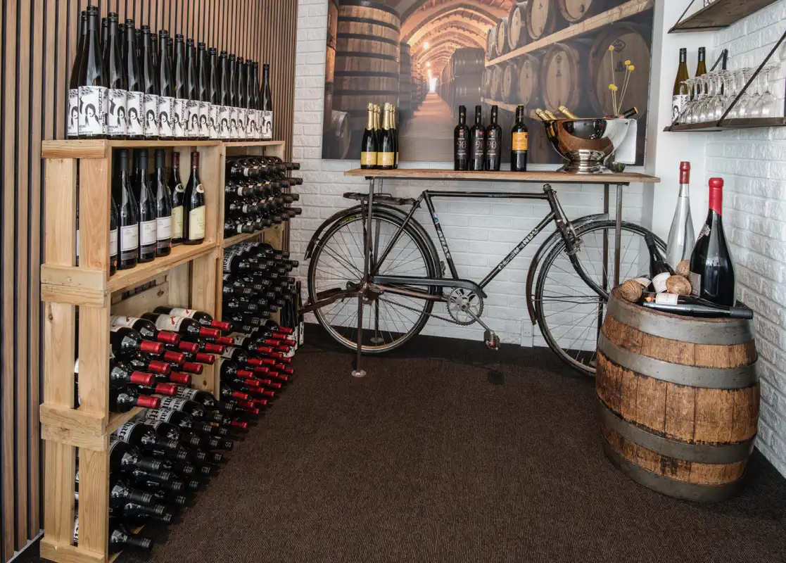 Vinreol og gammel cykel i Havestuen på Venge Kloster.