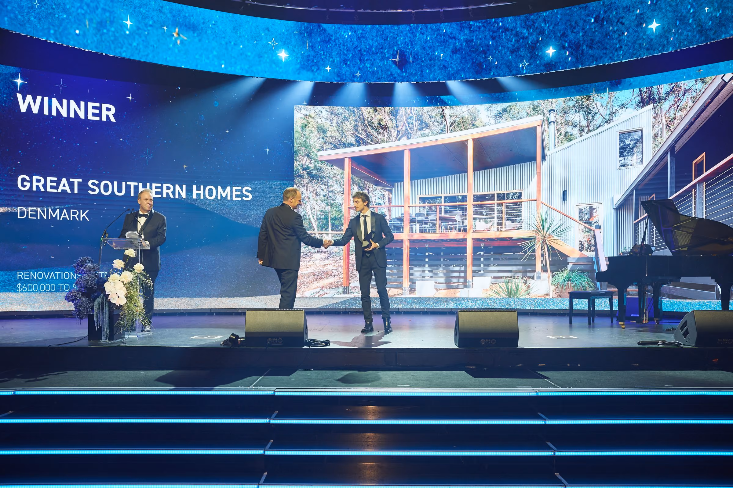 Michael Smyth accepting the 2025 Master Builders WA Building Excellence Award on stage