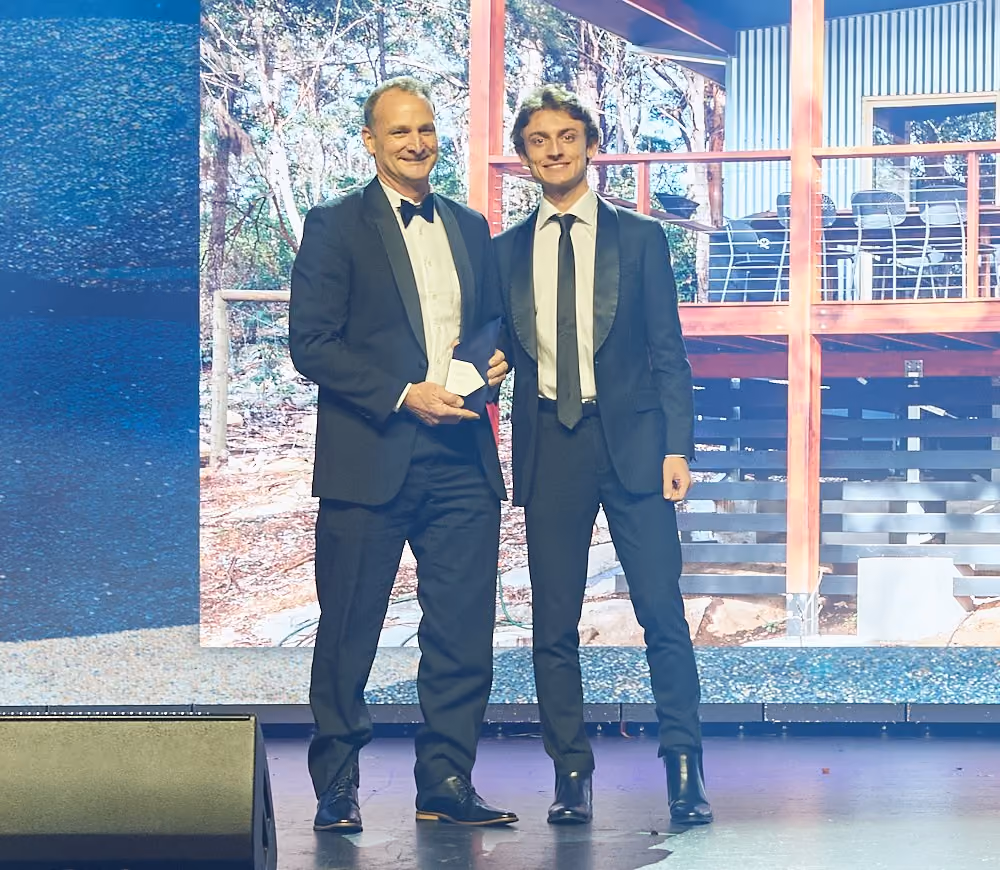 Michael Smyth accepting the 2025 Master Builders WA Building Excellence Award on stage