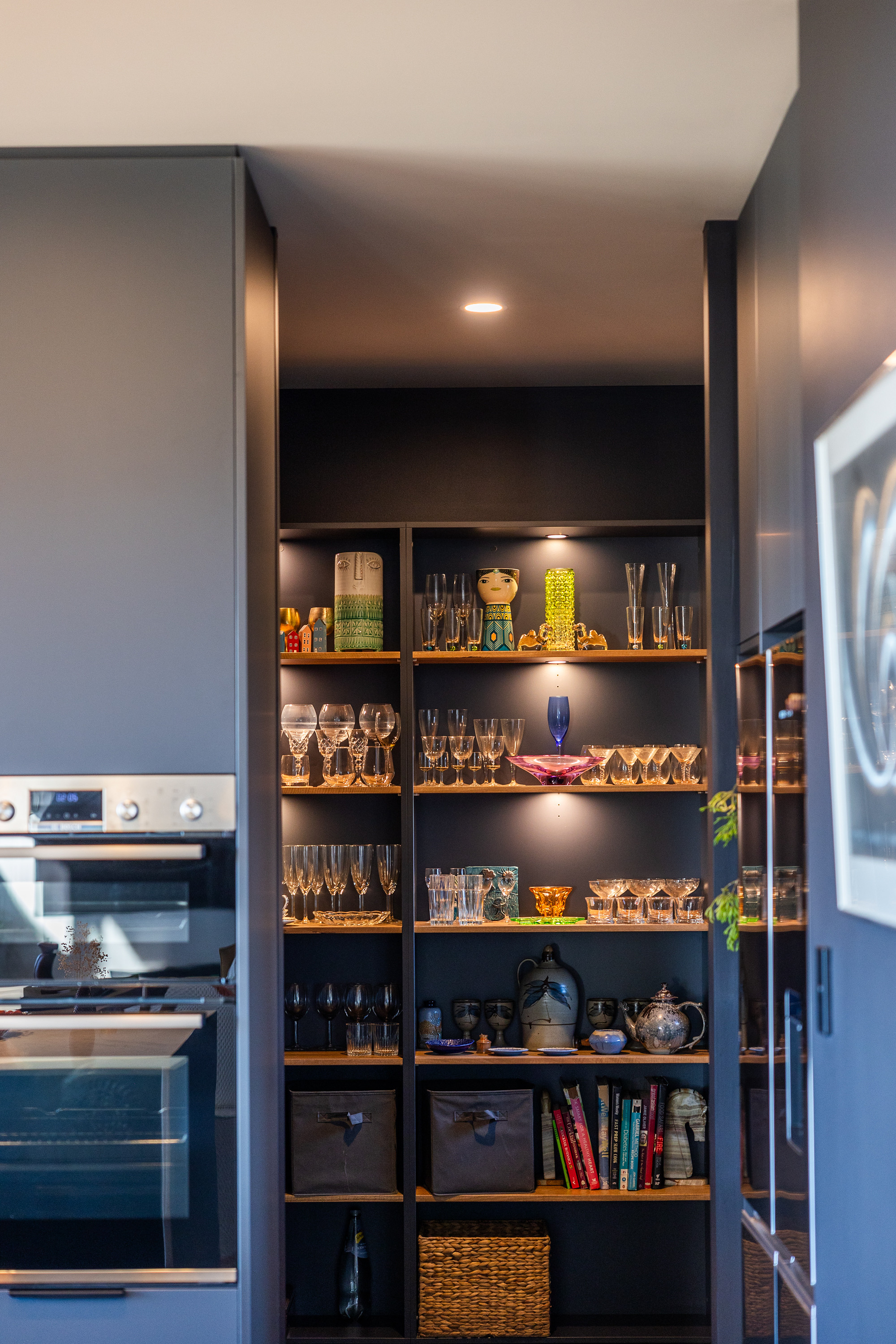 Lit timber shelving in the butler's pantry of a custom home in Denmark, WA