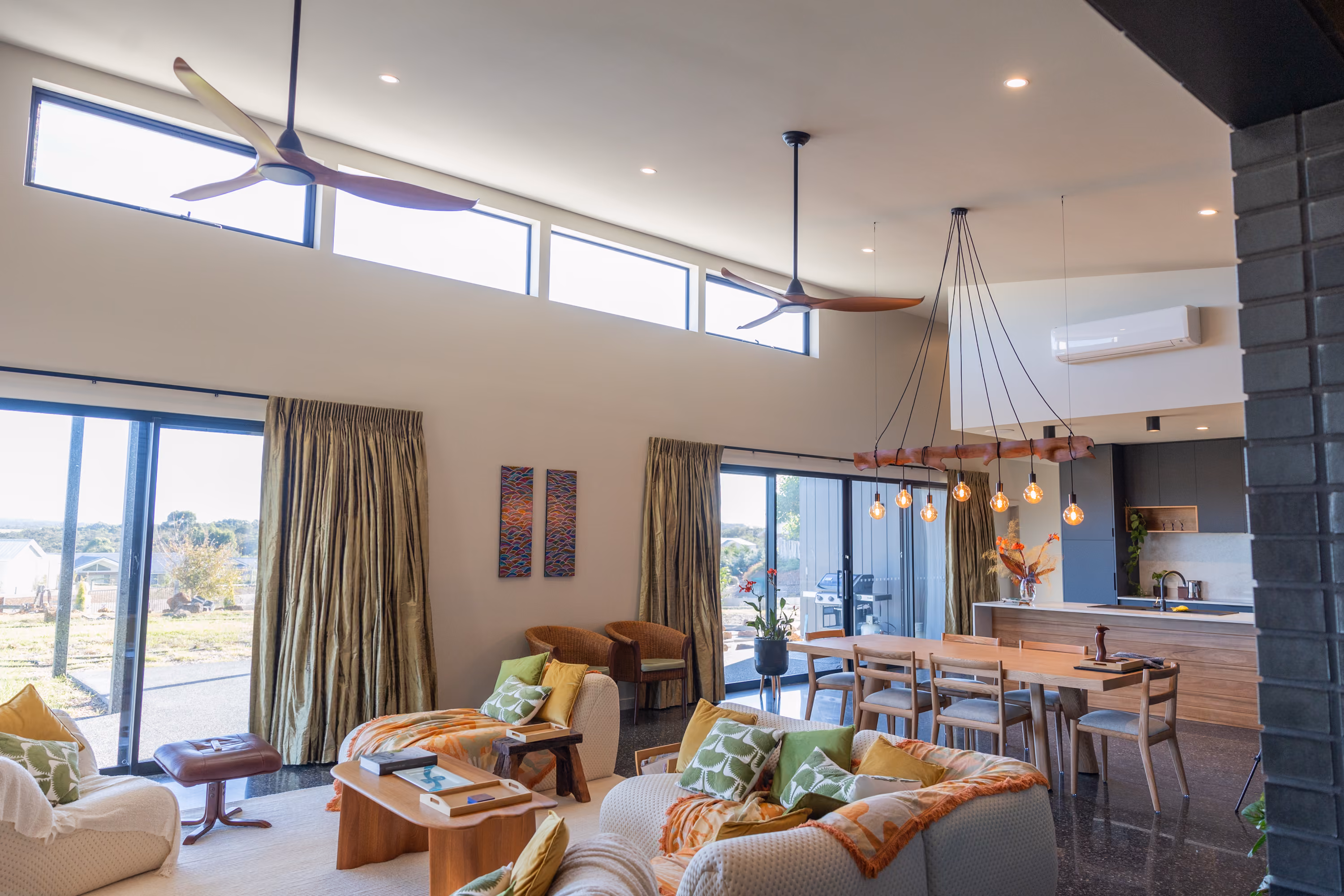 Great room of a custom home in Denmark, WA, with high clerestory windows over the lounge, dining and kitchen