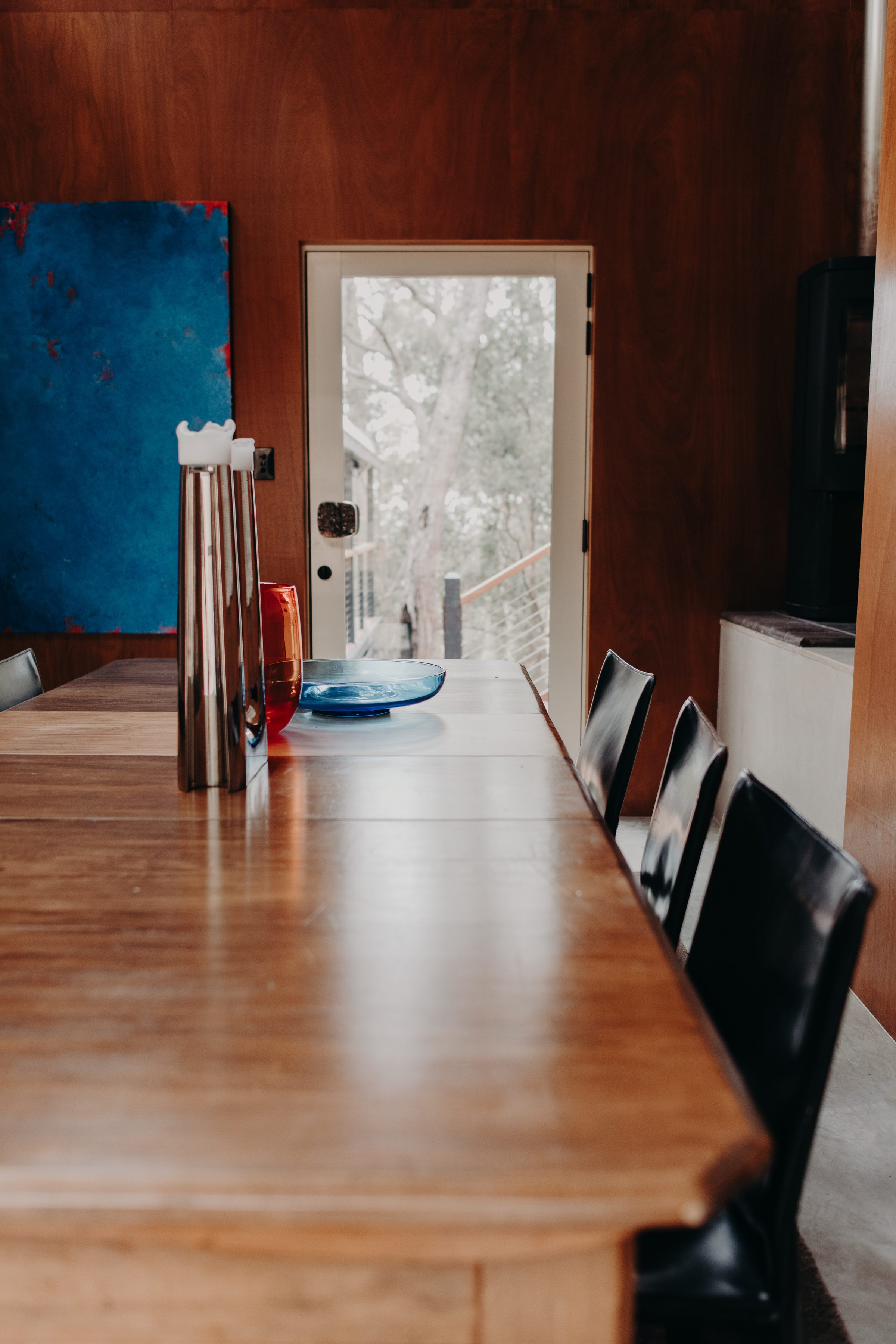 Long timber dining table in the living pavilion of a renovated home in Denmark, WA