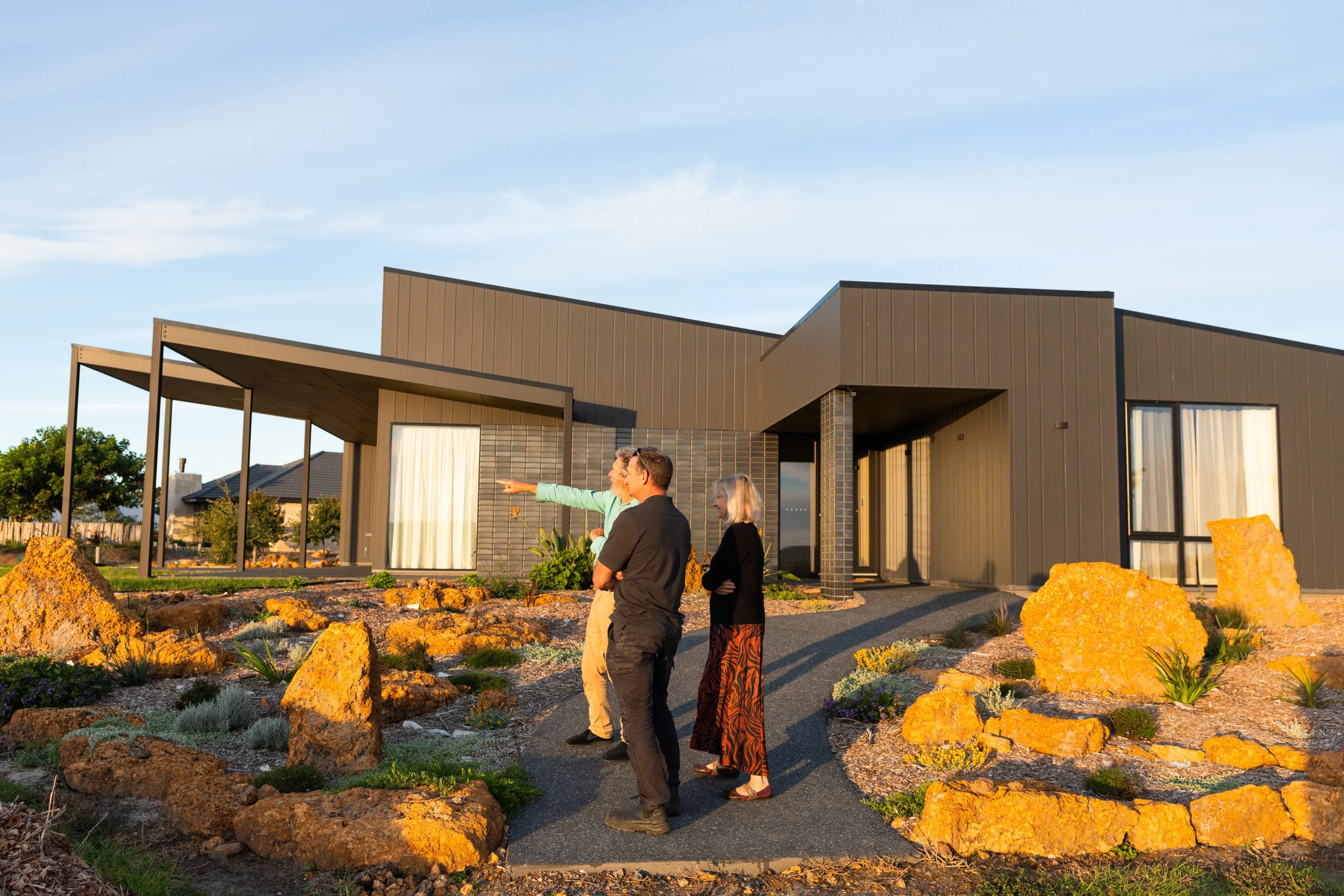 Michael Smyth walking homeowners through the garden of their new home in Denmark, WA