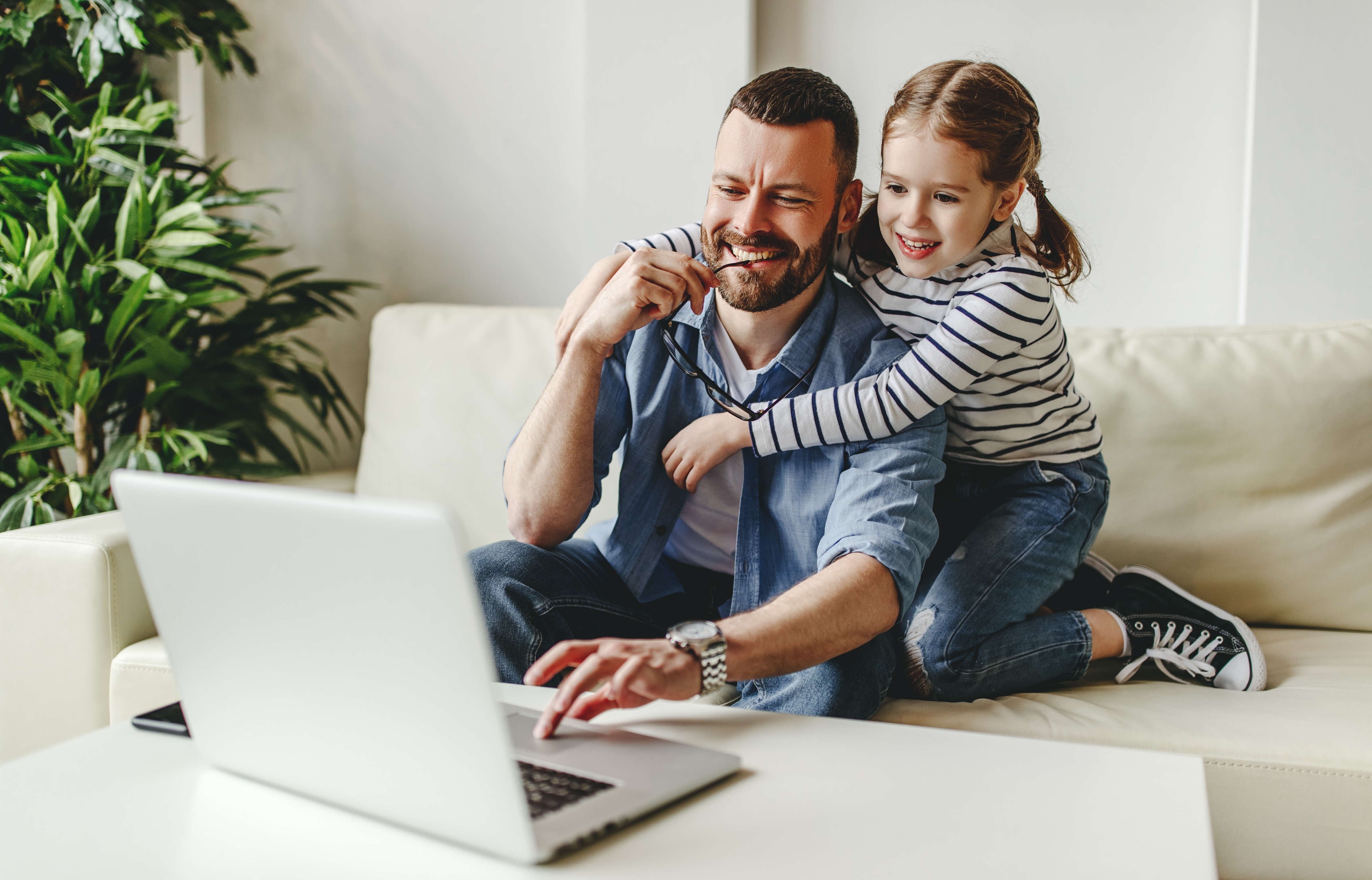 Man and little girl on couch stock image