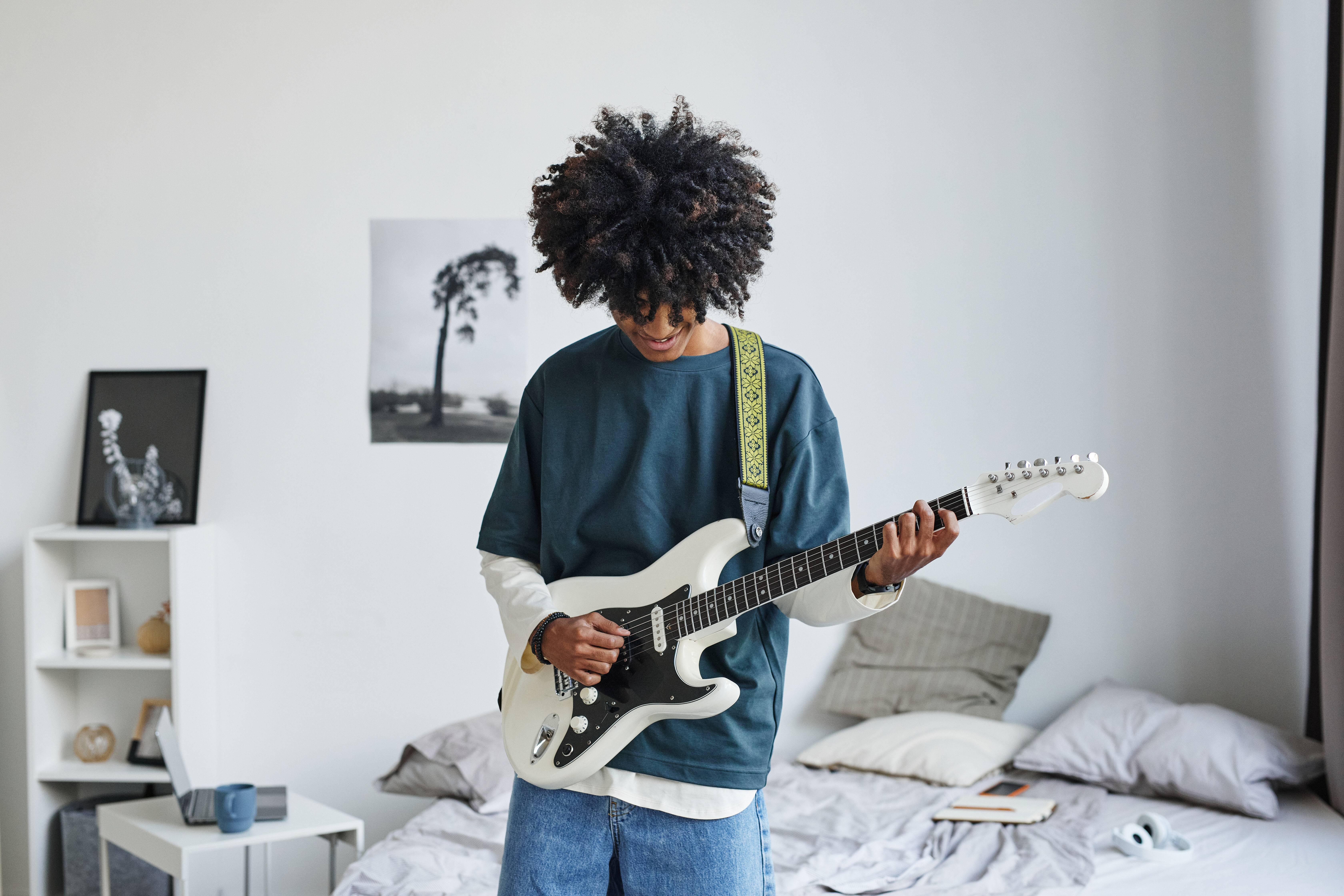 Man playing guitar in room stock image
