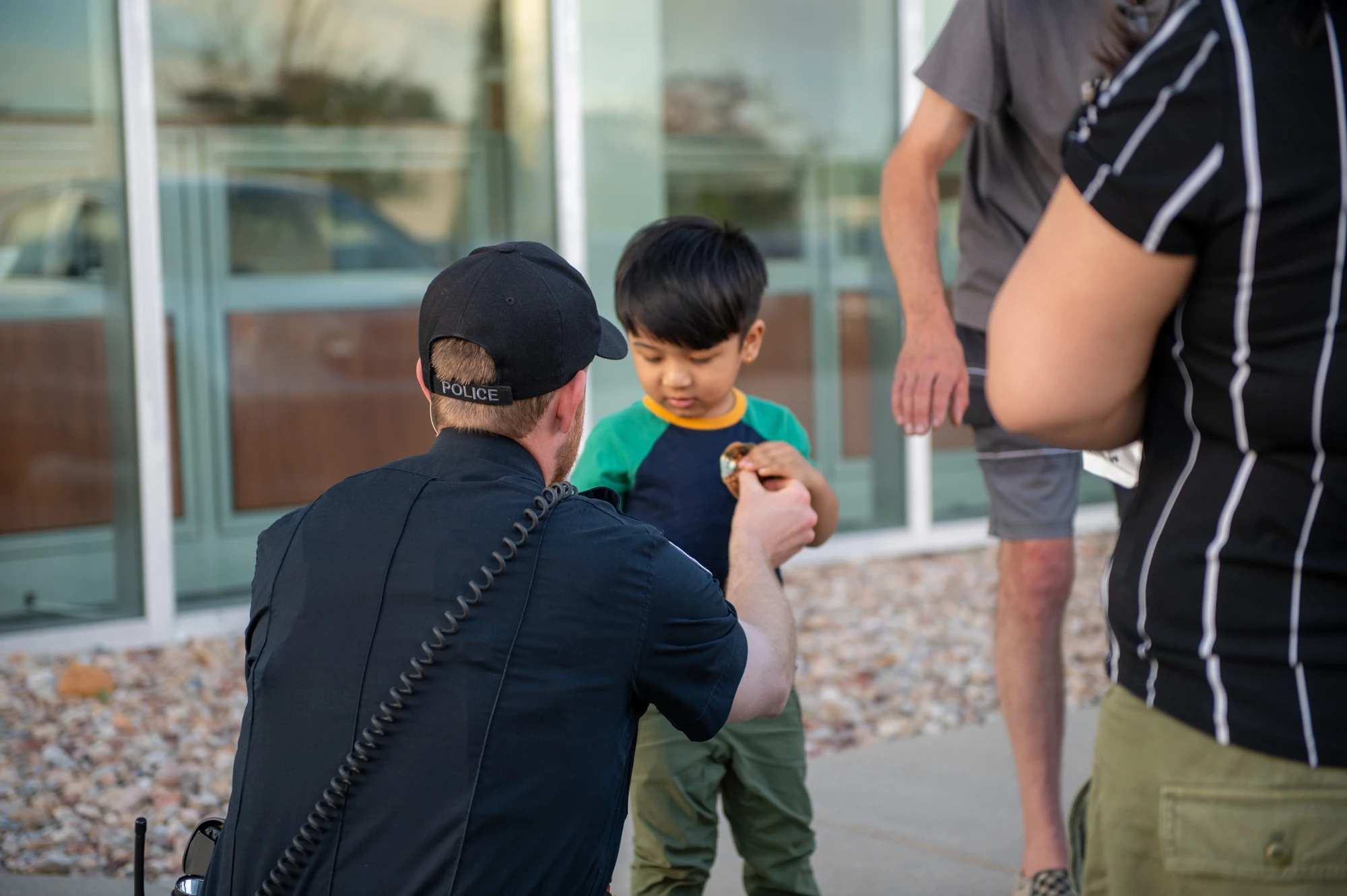 A Boulder police officer on duty outside a community building.
