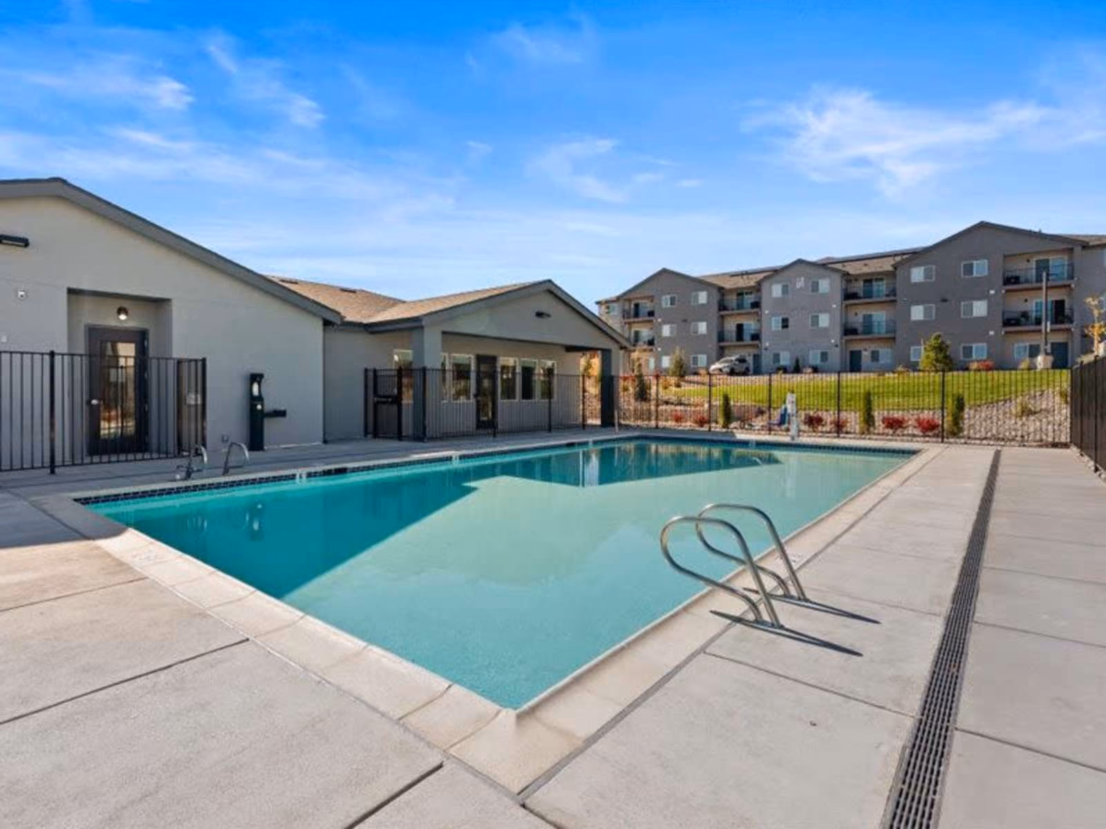 Gated swimming pool with view of exterior and residents lounge