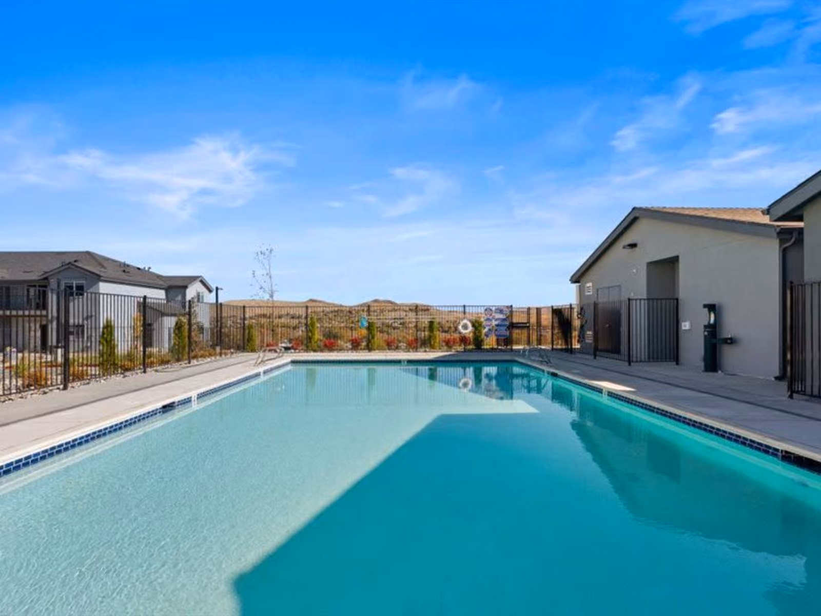 Gated swimming pool with view of exterior of residents lounge