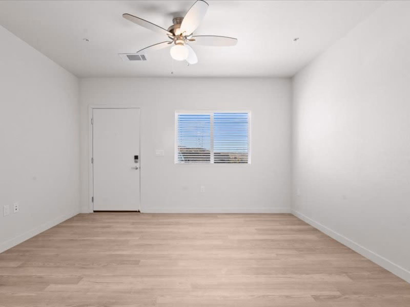 Unfurnished bedroom with large window and ceiling fan