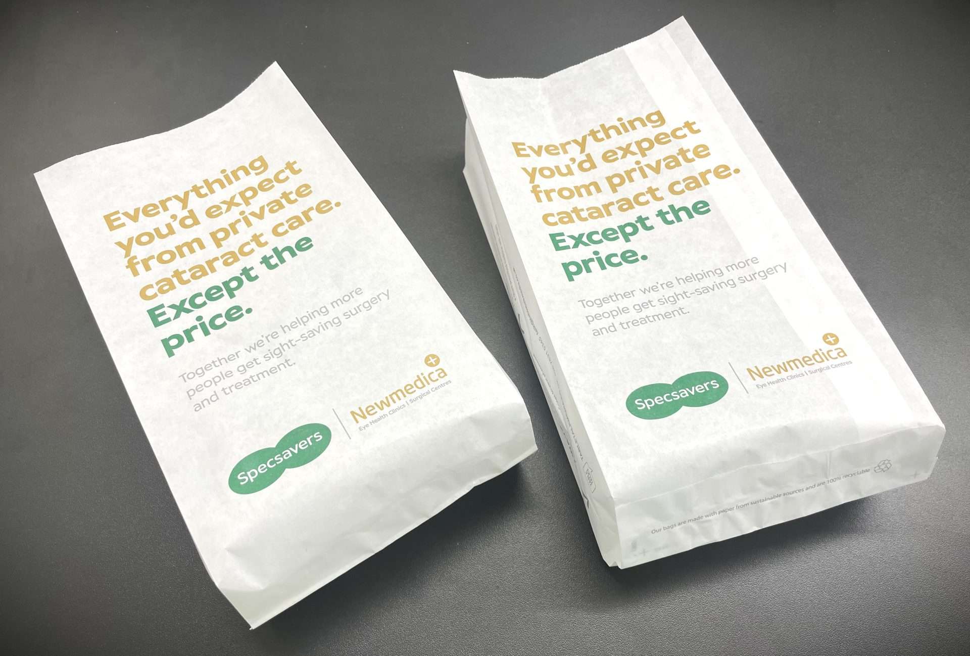 Two white Specsavers and Newmedica pharmacy bags reading 'Everything you'd expect from private cataract care. Except the price.'