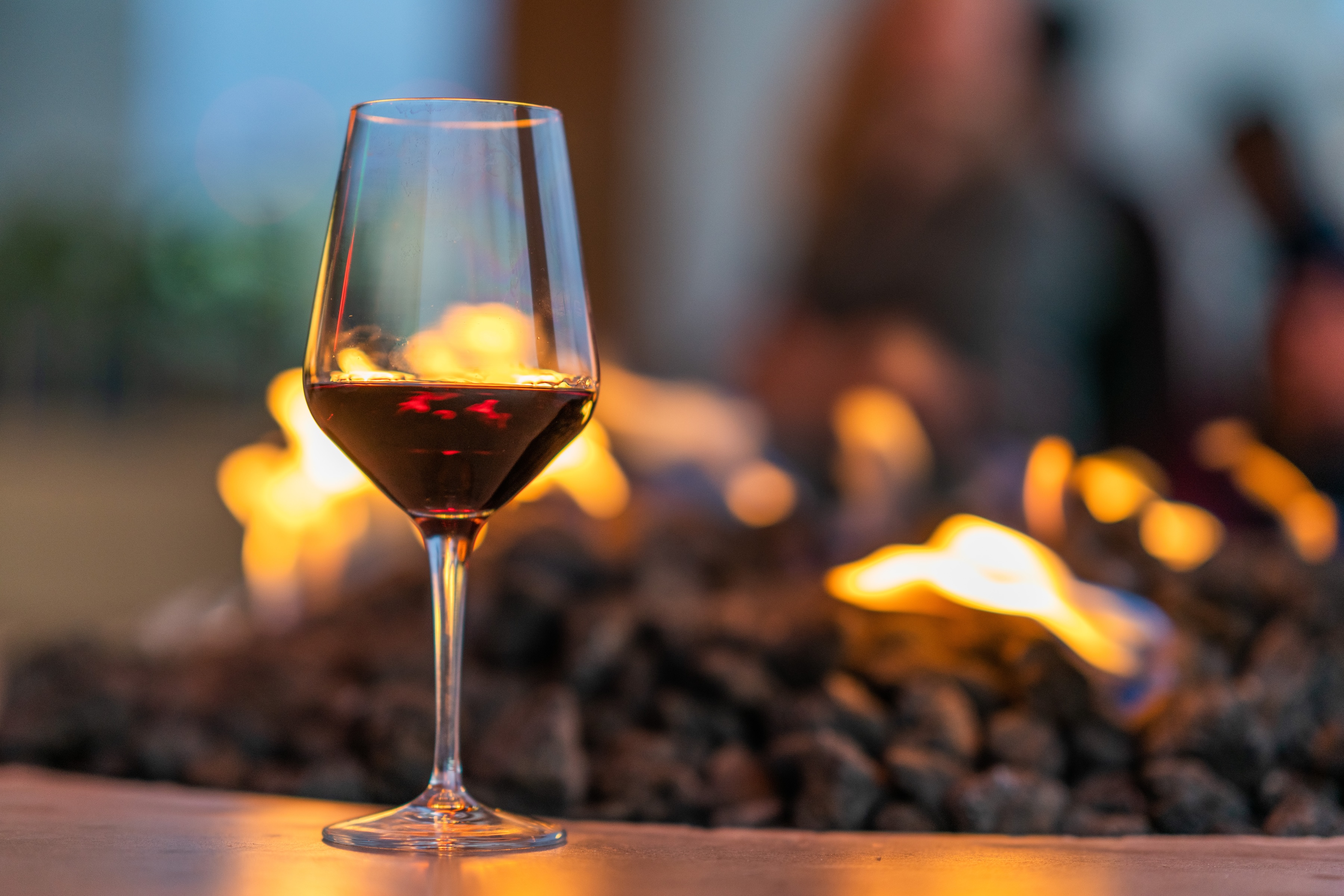 Wine glass with an outdoor fireplace stock image