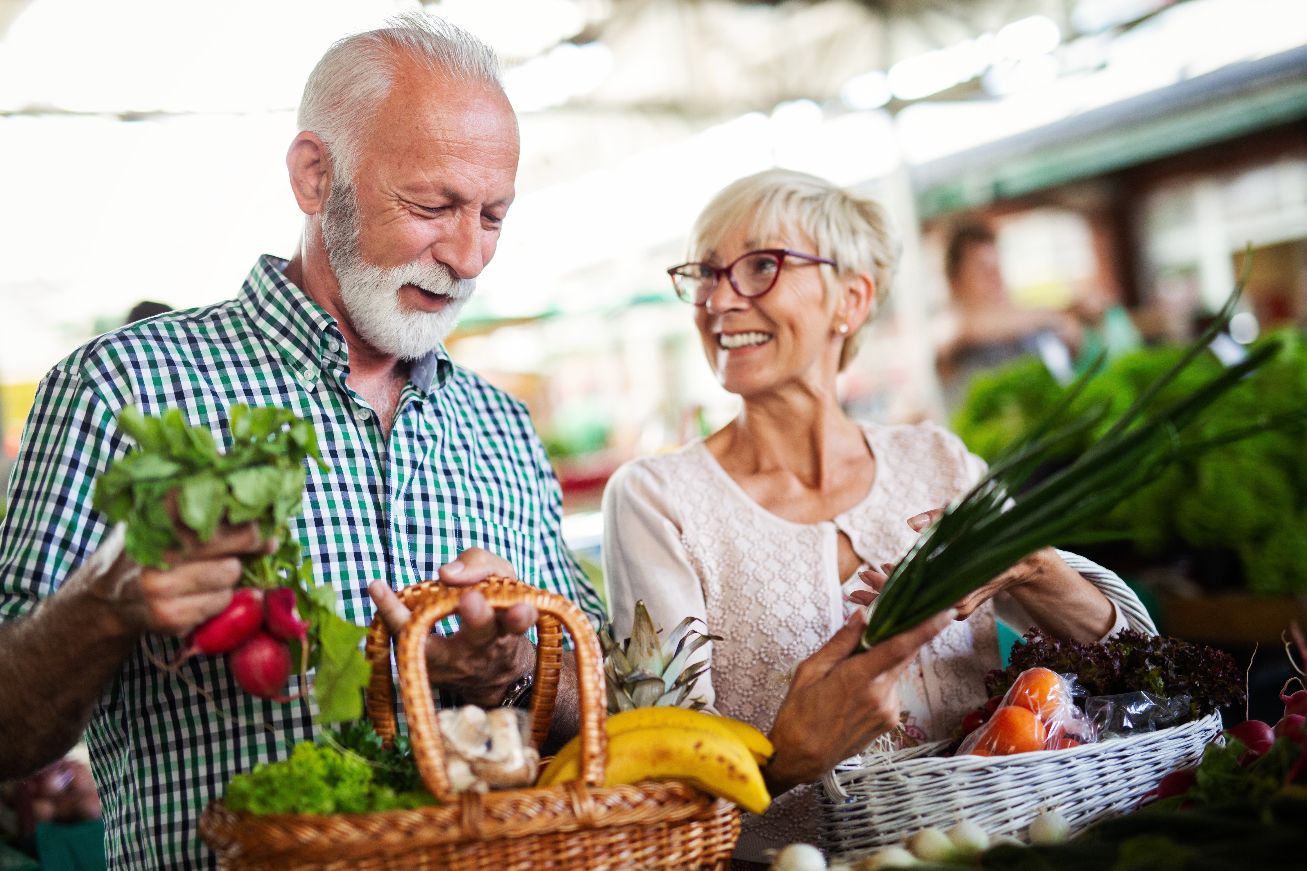 Man and woman at the grocery store stock image