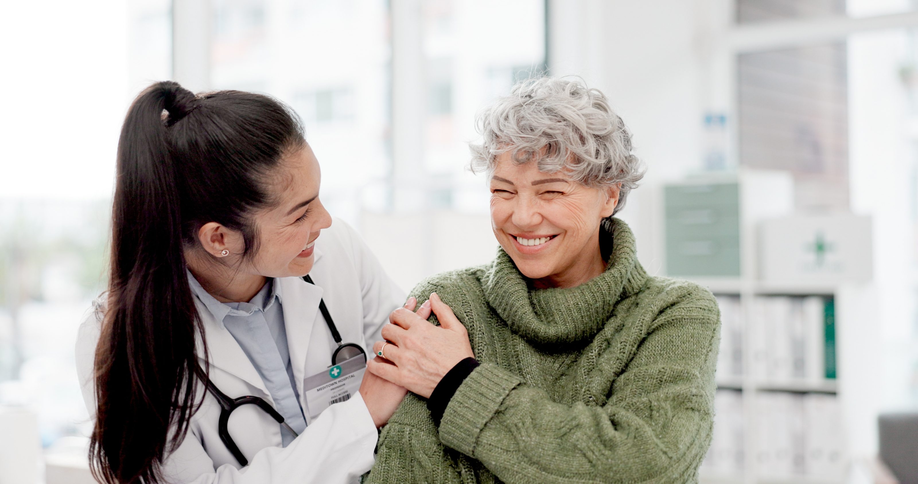 A clinician sitting with a patient during a clinical trial study visit in Miami
