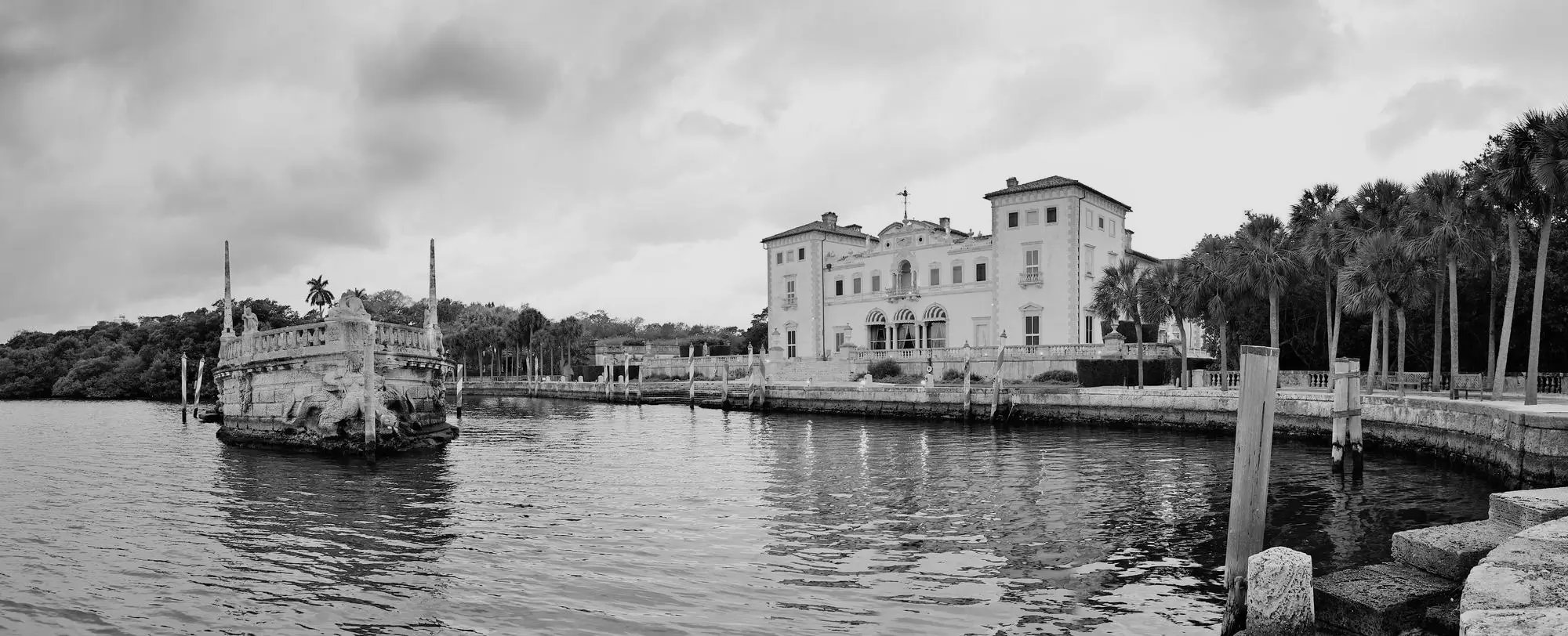 Black and white view of a historic waterfront building across the water
