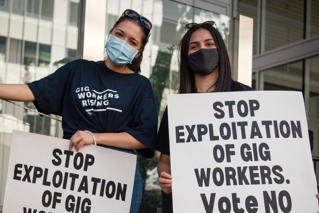 gig workers protesting with signs