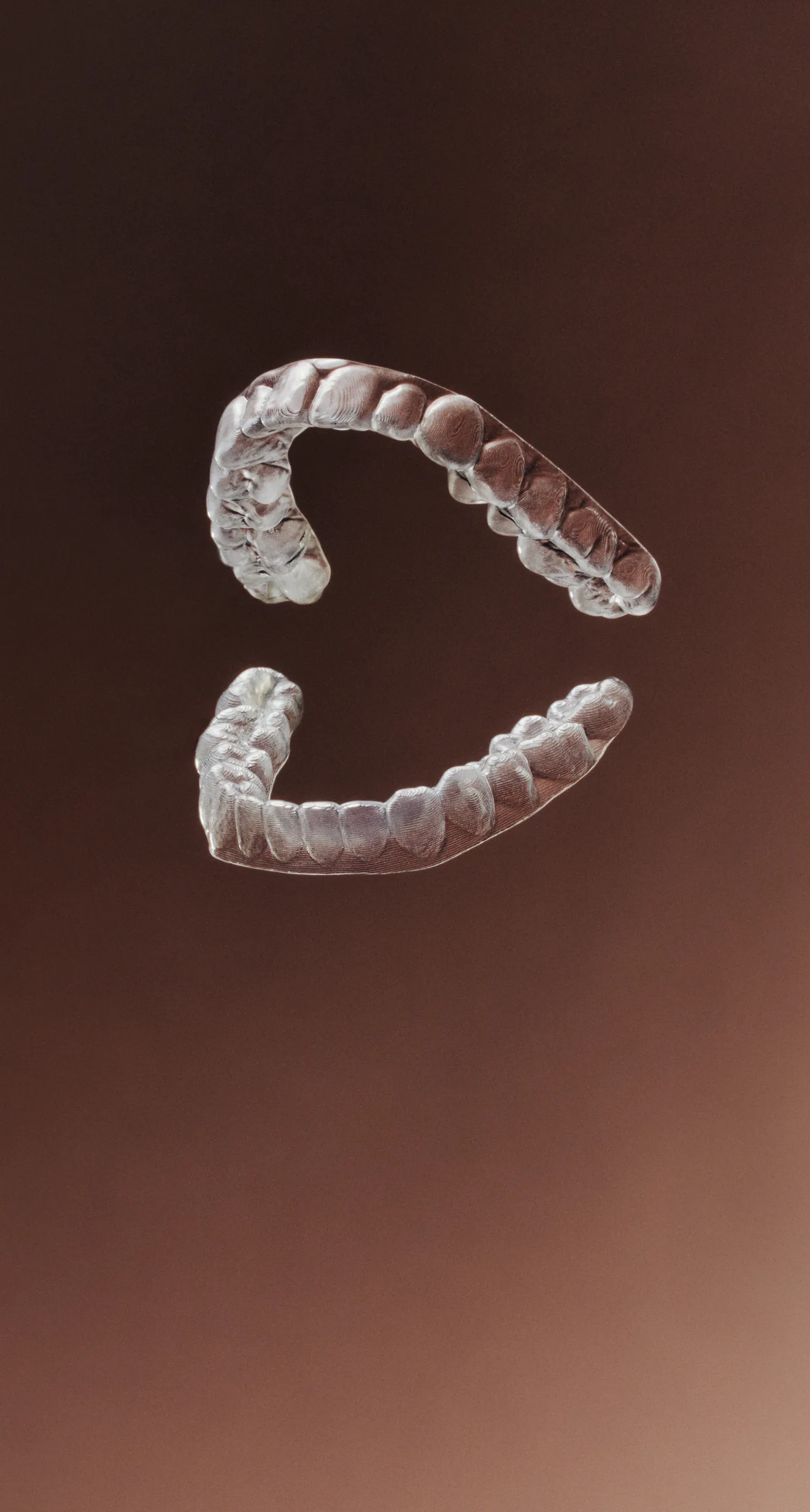 Clear upper and lower retainers against a dark brown background