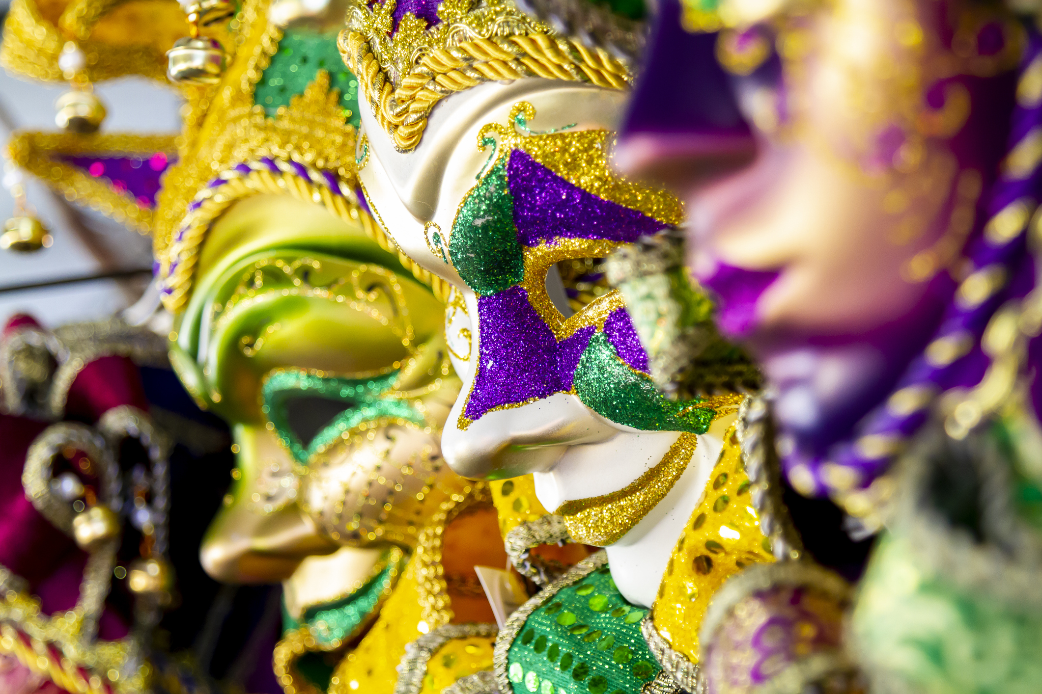 Mardi Gras masks in purple, green, and gold