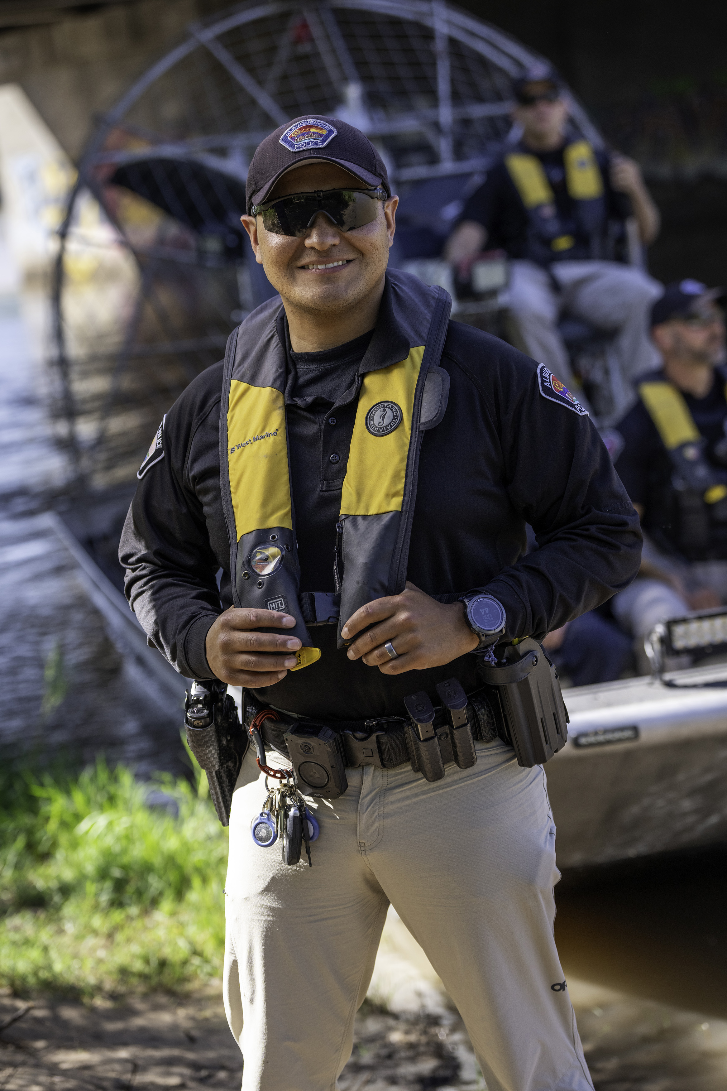 Public safety officer wearing a life vest near rescue equipment
