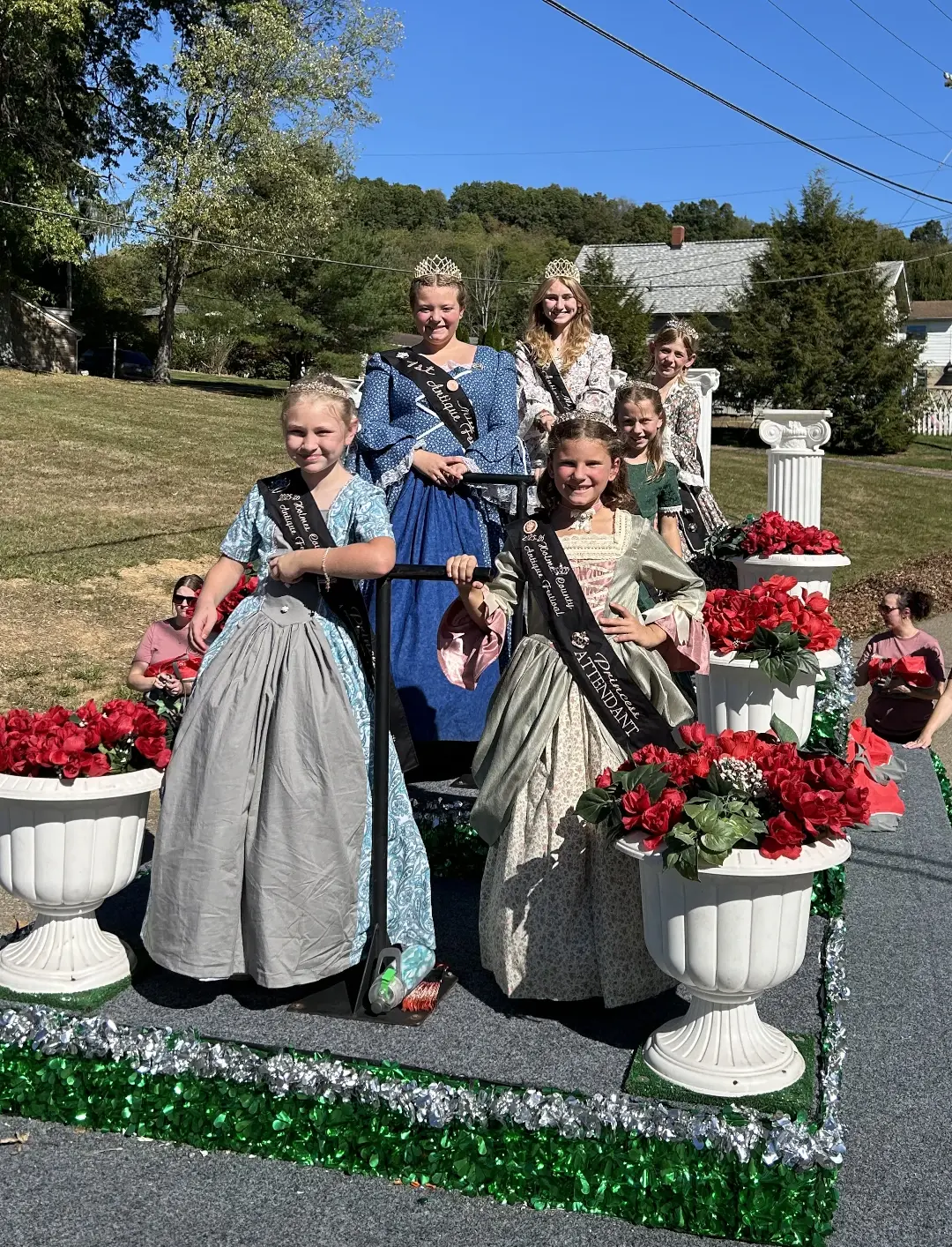 queens and princesses on a parade float
