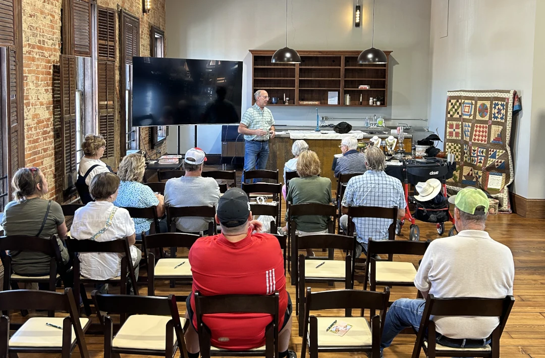 group of watchers listening to someone give a presentation