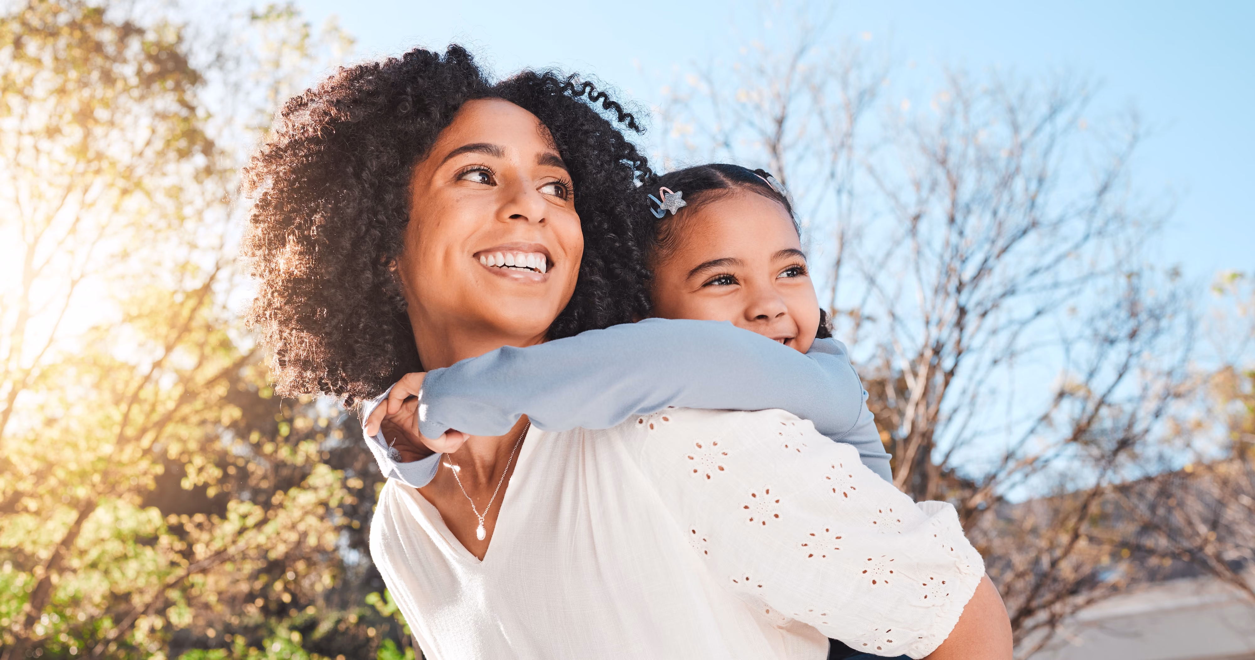 Woman with child on her back stock image