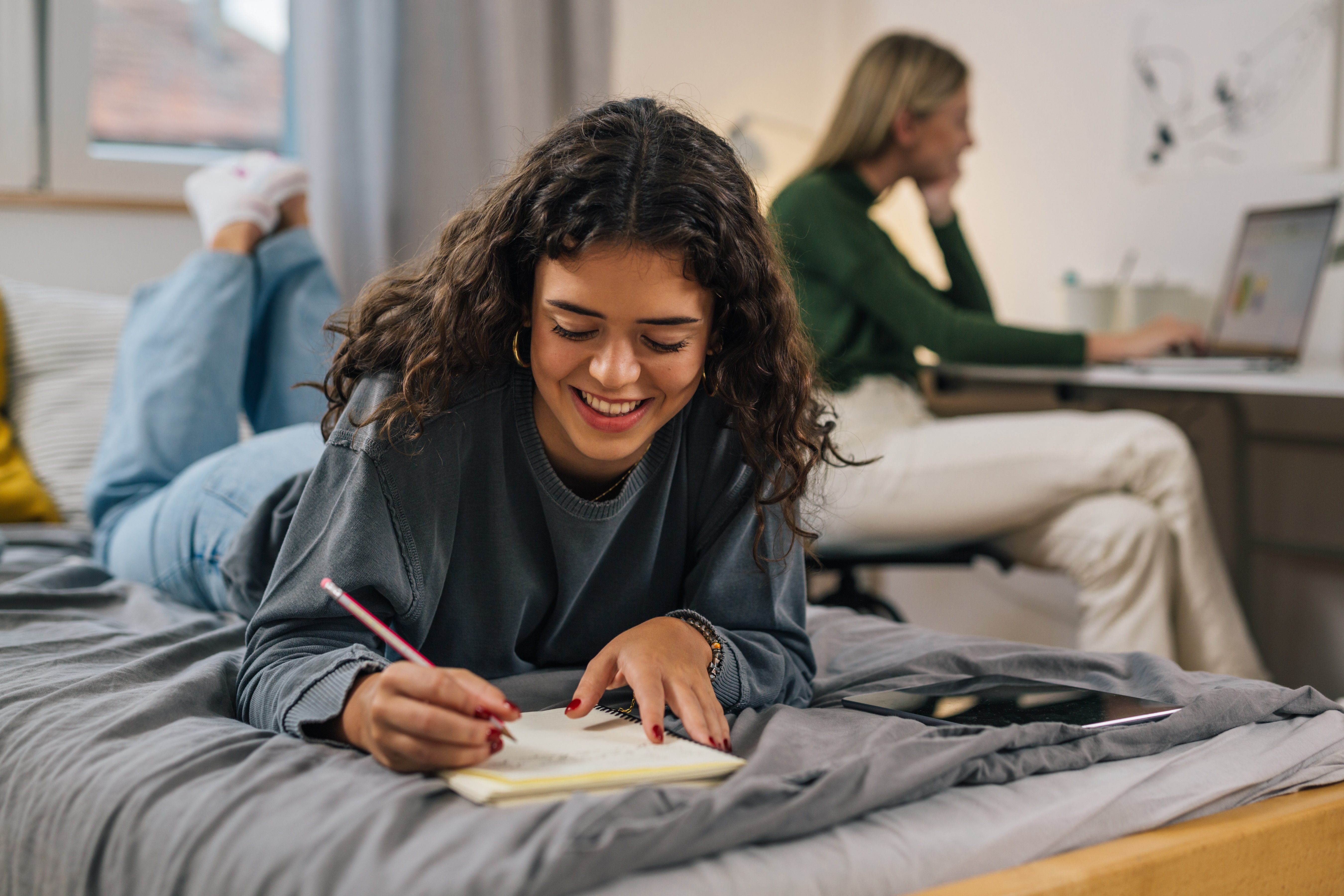 Girl writing on bed stock image