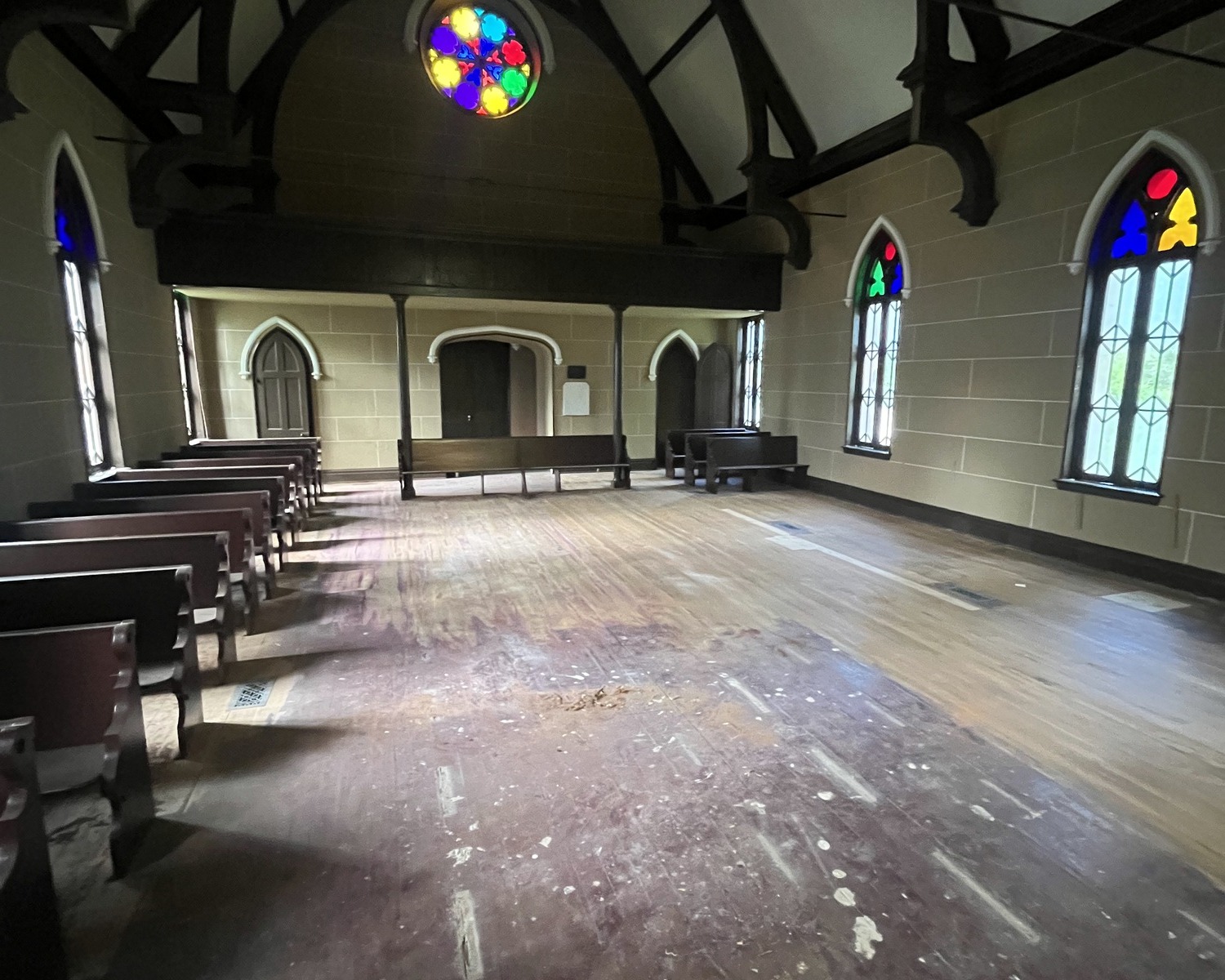Christ Church sanctuary during restoration, showing work in progress and stained glass.