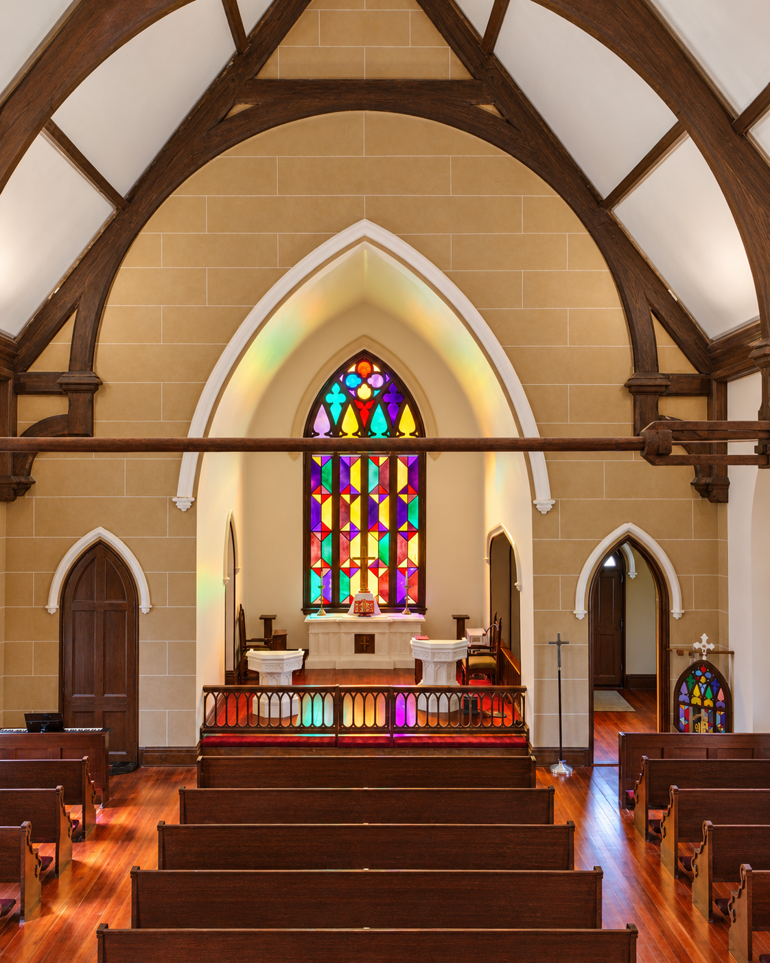 Gothic arches and stained glass in the sanctuary.