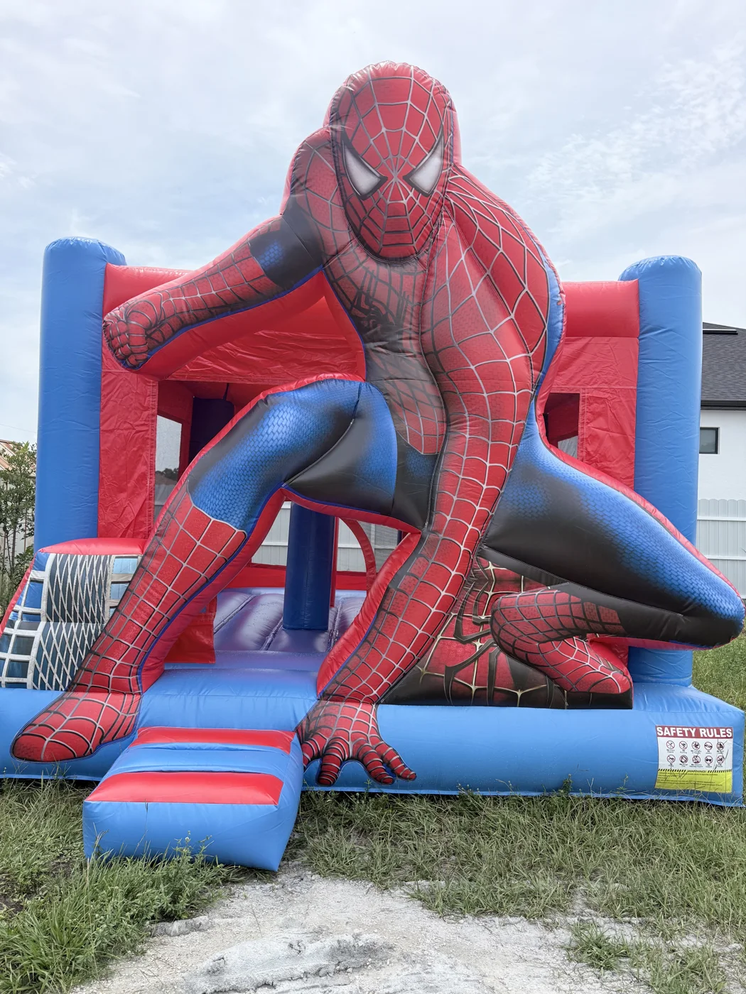 Red-and-blue Spider-Man inflatable with web graphics and a large character figure.