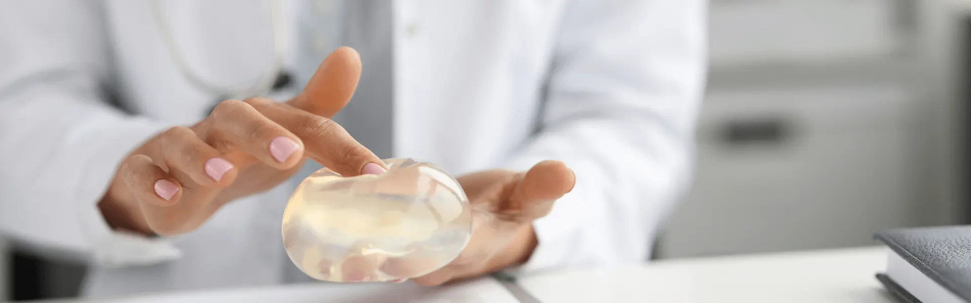 Person holding a breast implant