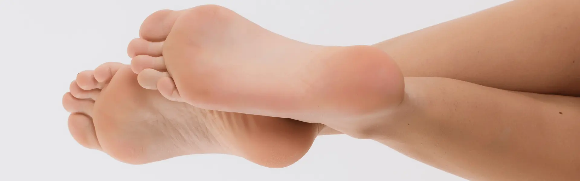 Bare feet with the soles facing the camera