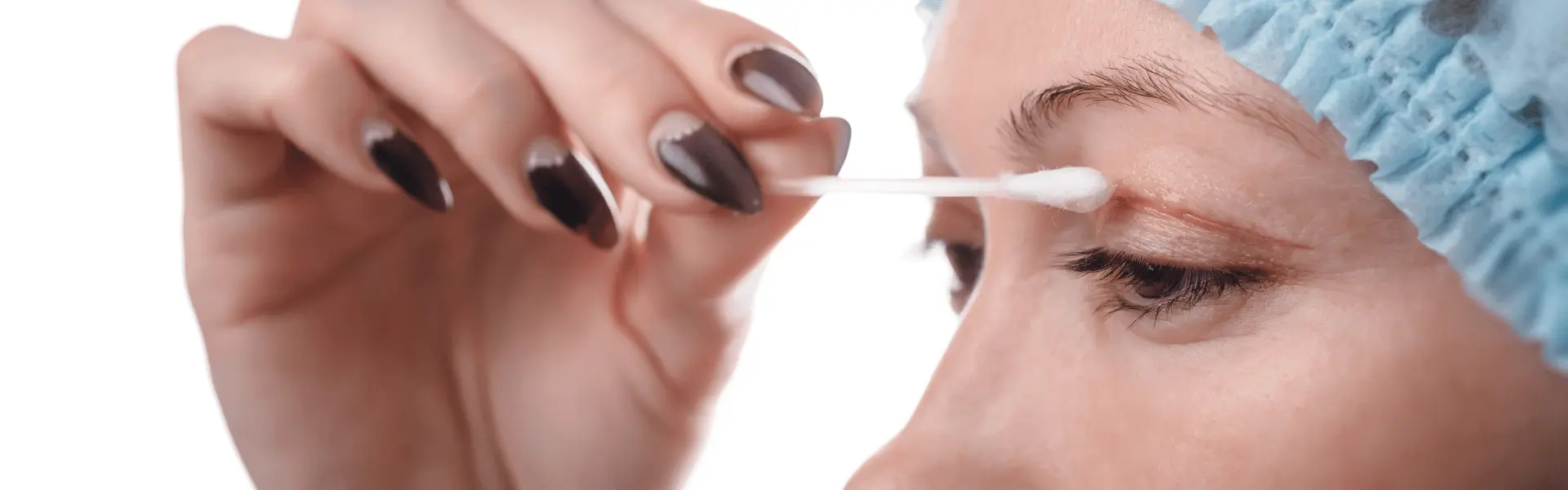 Cotton swab held against a woman's upper eyelid.