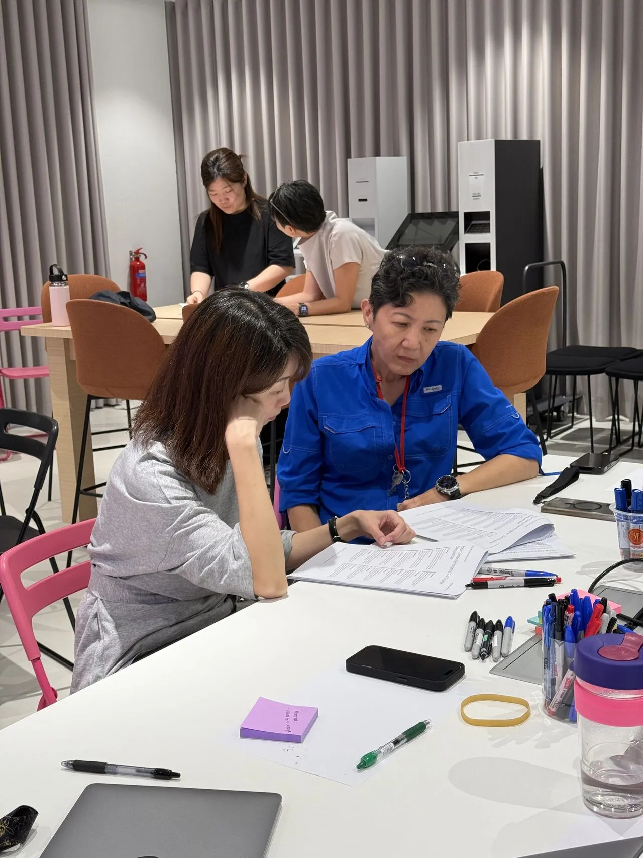 Participants working through a coaching exercise together